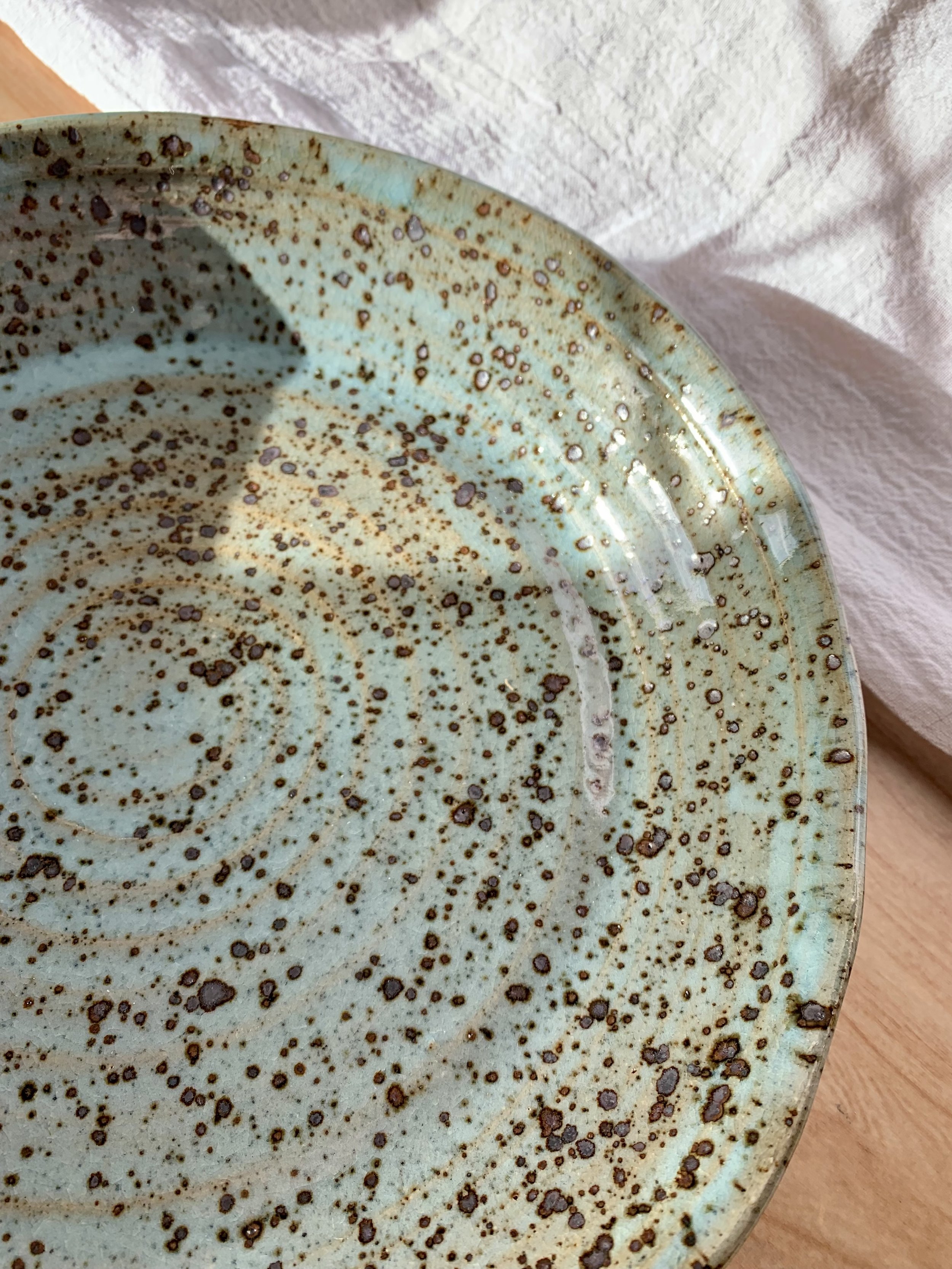 Detail of large serving dish, stoneware with blue Chun glaze, reduction fired.