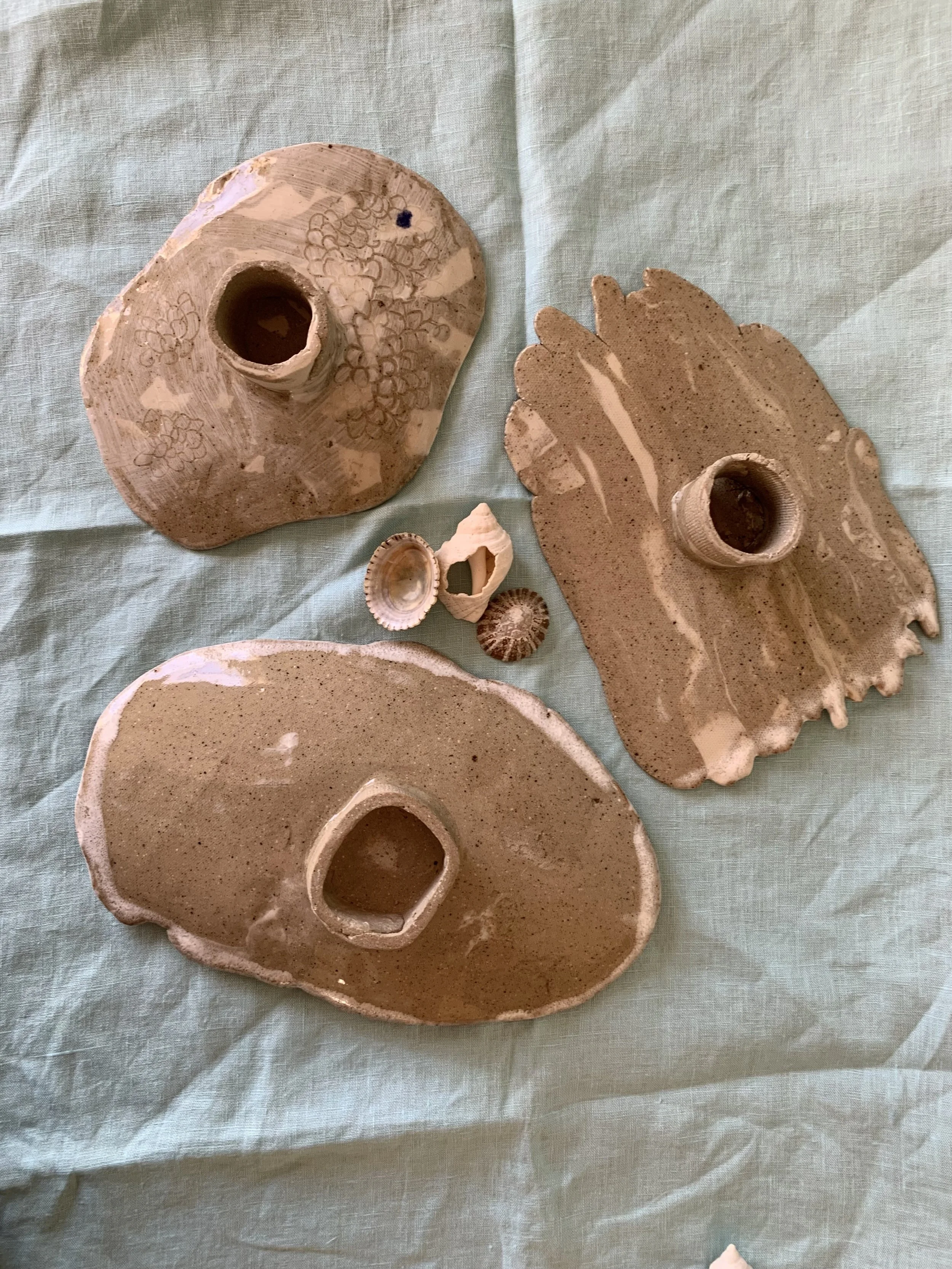 Underside of three medium stilted Nerikomi serving dishes, clear glazed stoneware with slip