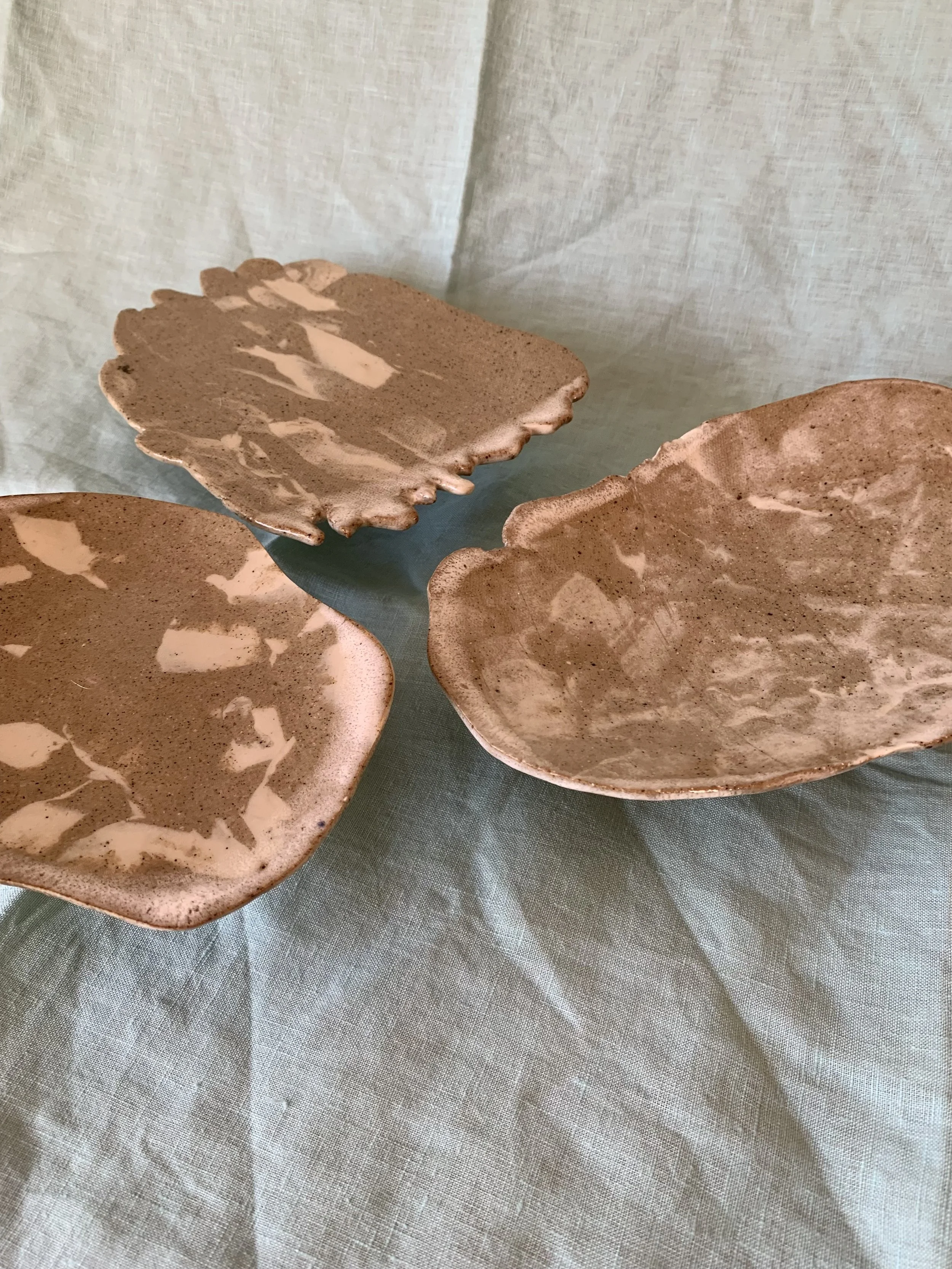 Three medium stilted Nerikomi serving dishes, clear glazed stoneware with slip