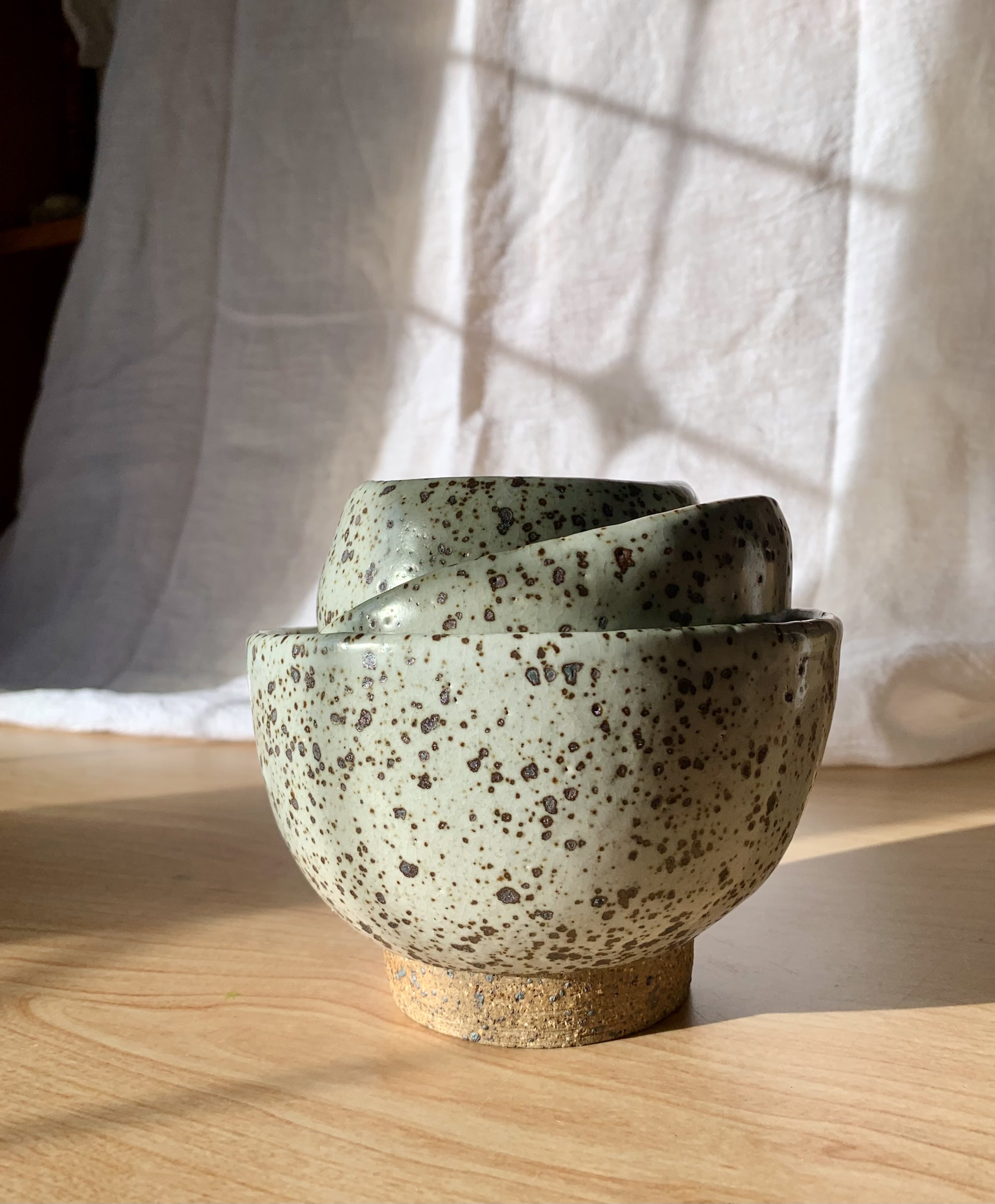 Set of three small footed bowls, reduction fired stoneware