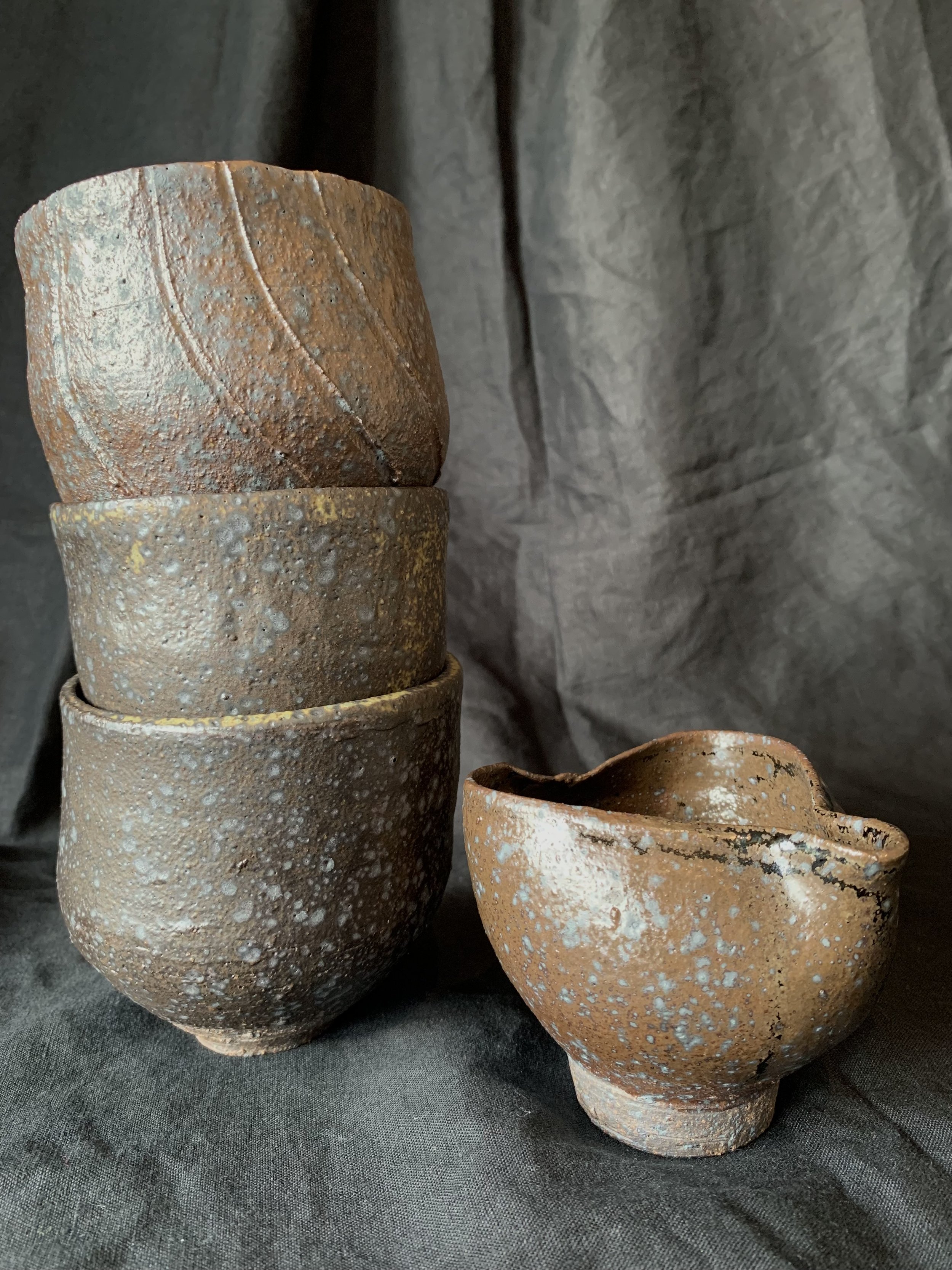 Three reduction fired stoneware cups with pourer