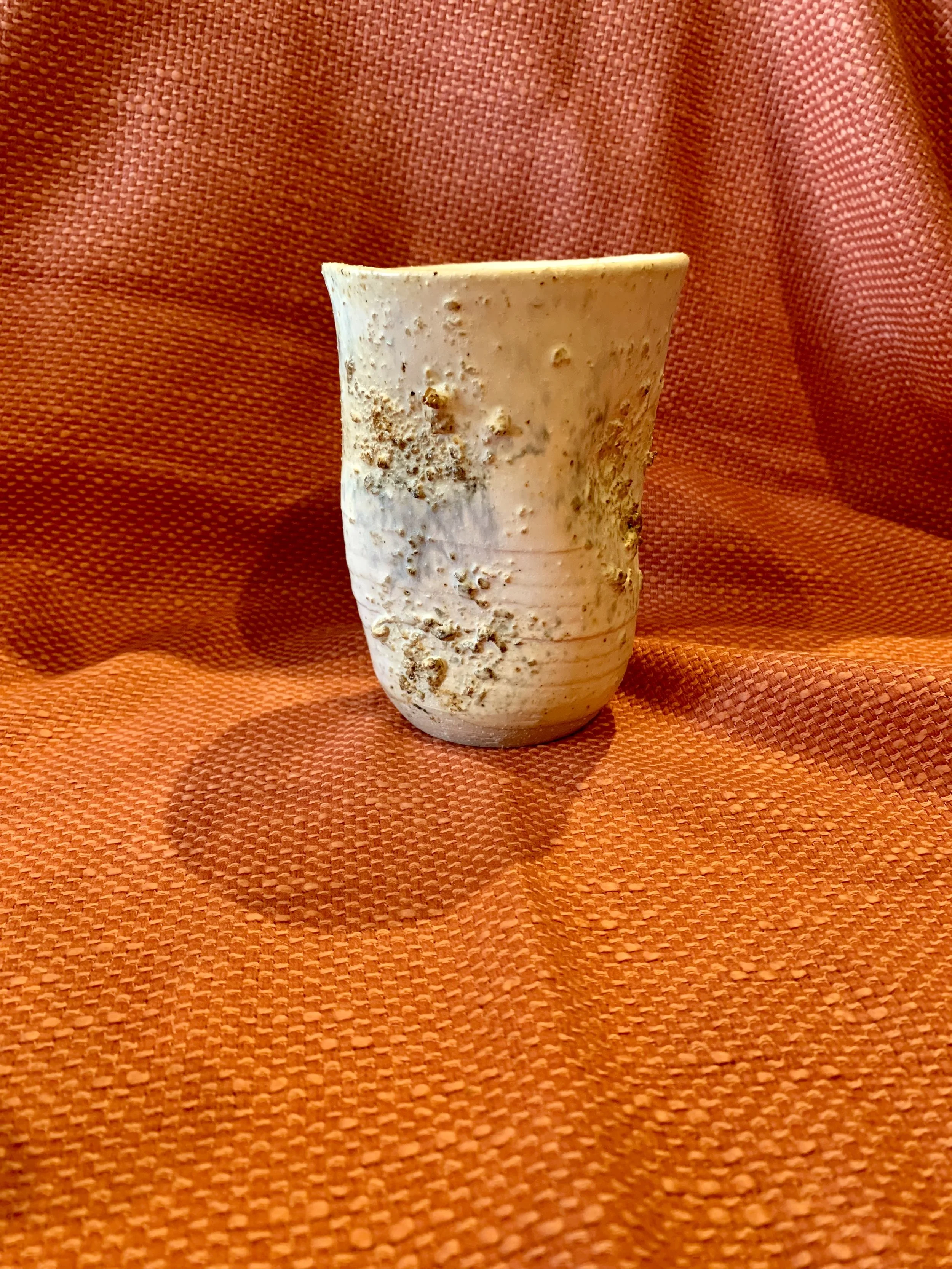 Thrown and altered stoneware vase with texture and oxide colouring