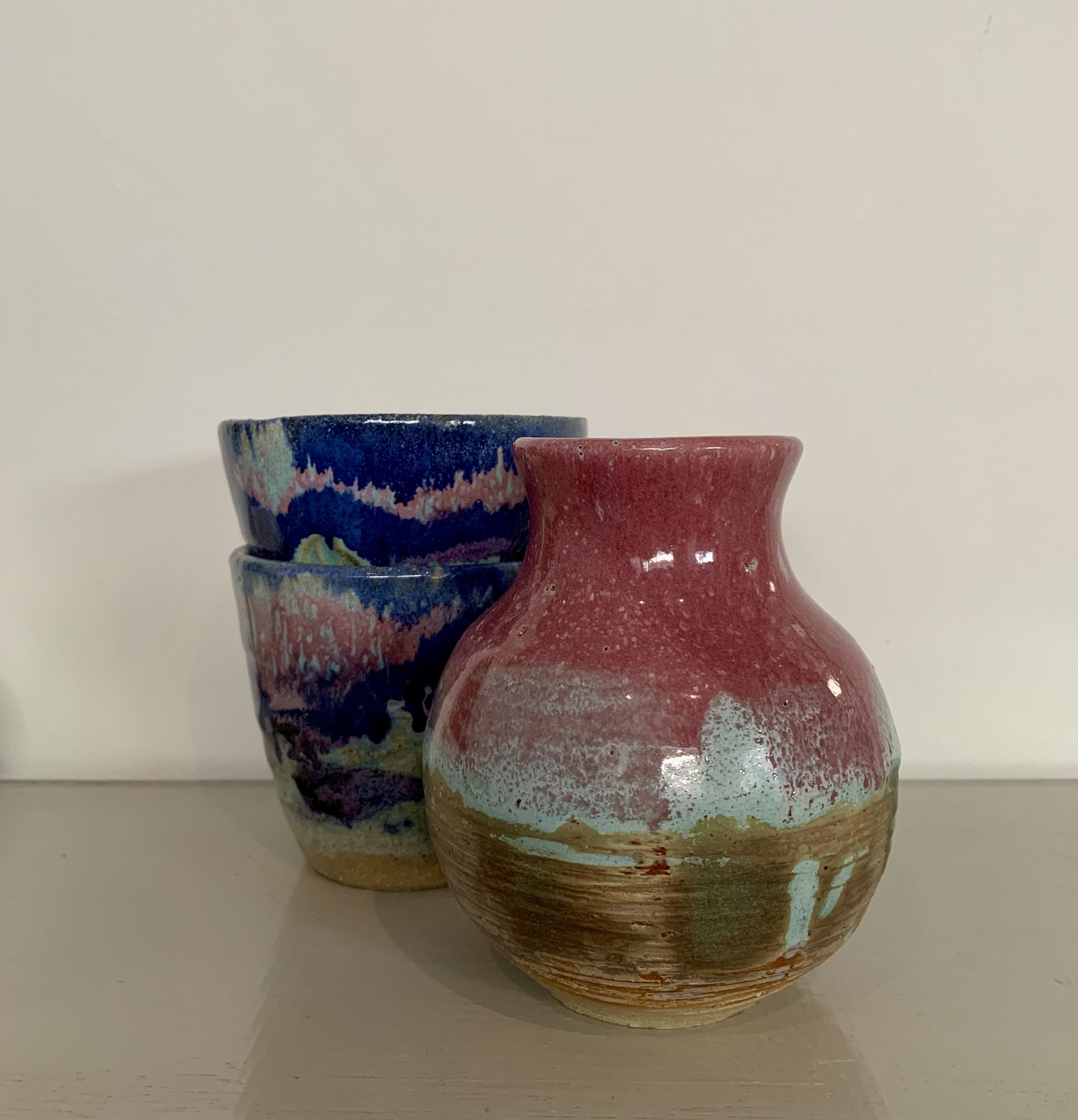 Pink vase with pink and blue tumblers, glazed stoneware