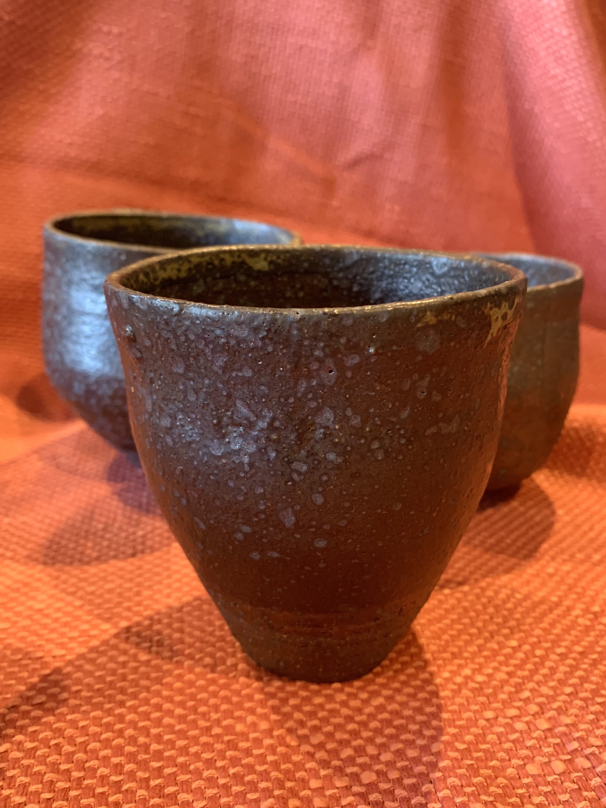 Tapered cup, dark reduction fired stoneware