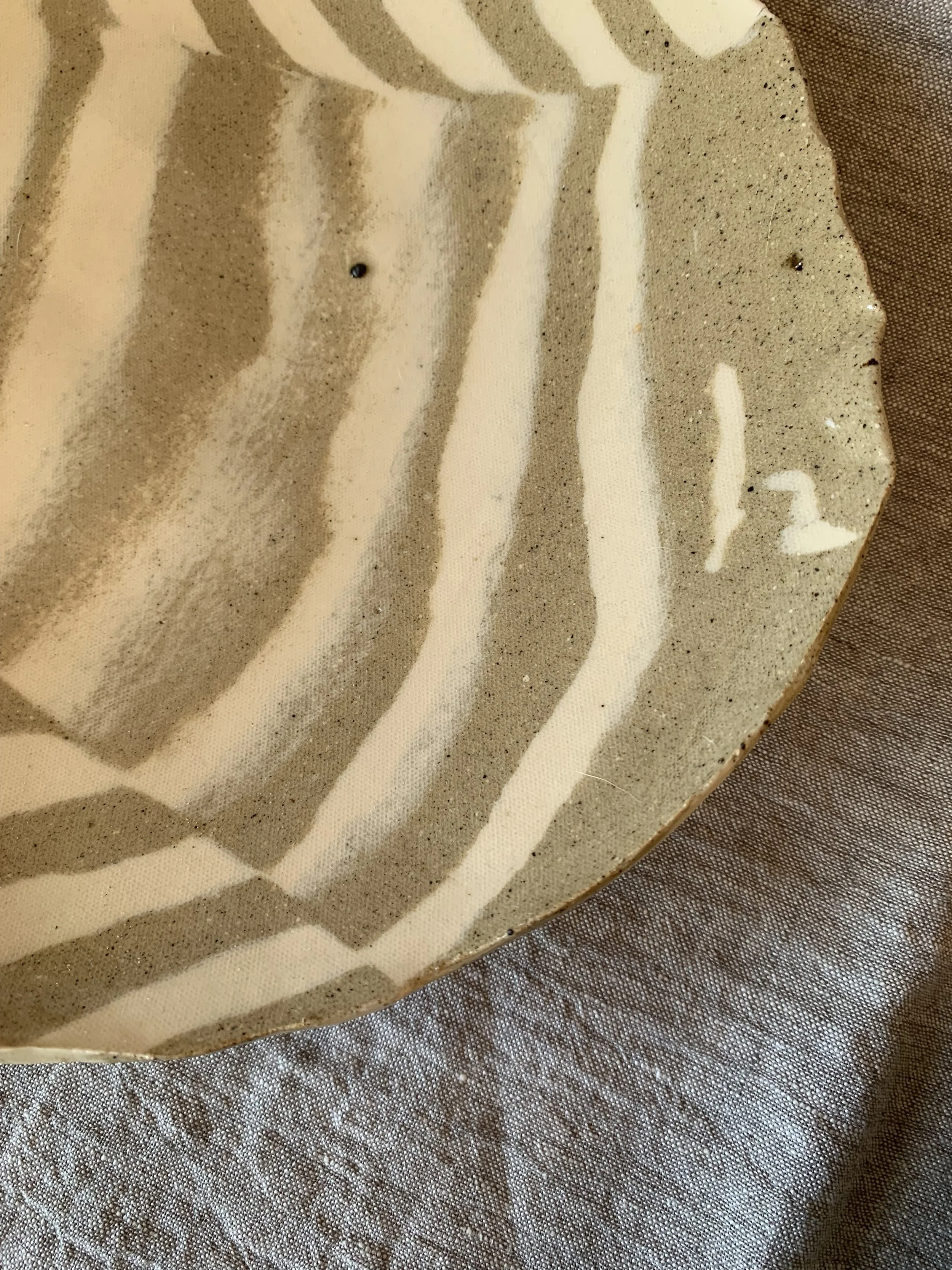 Detail of large striped Nerikomi serving dish, clear glazed stoneware