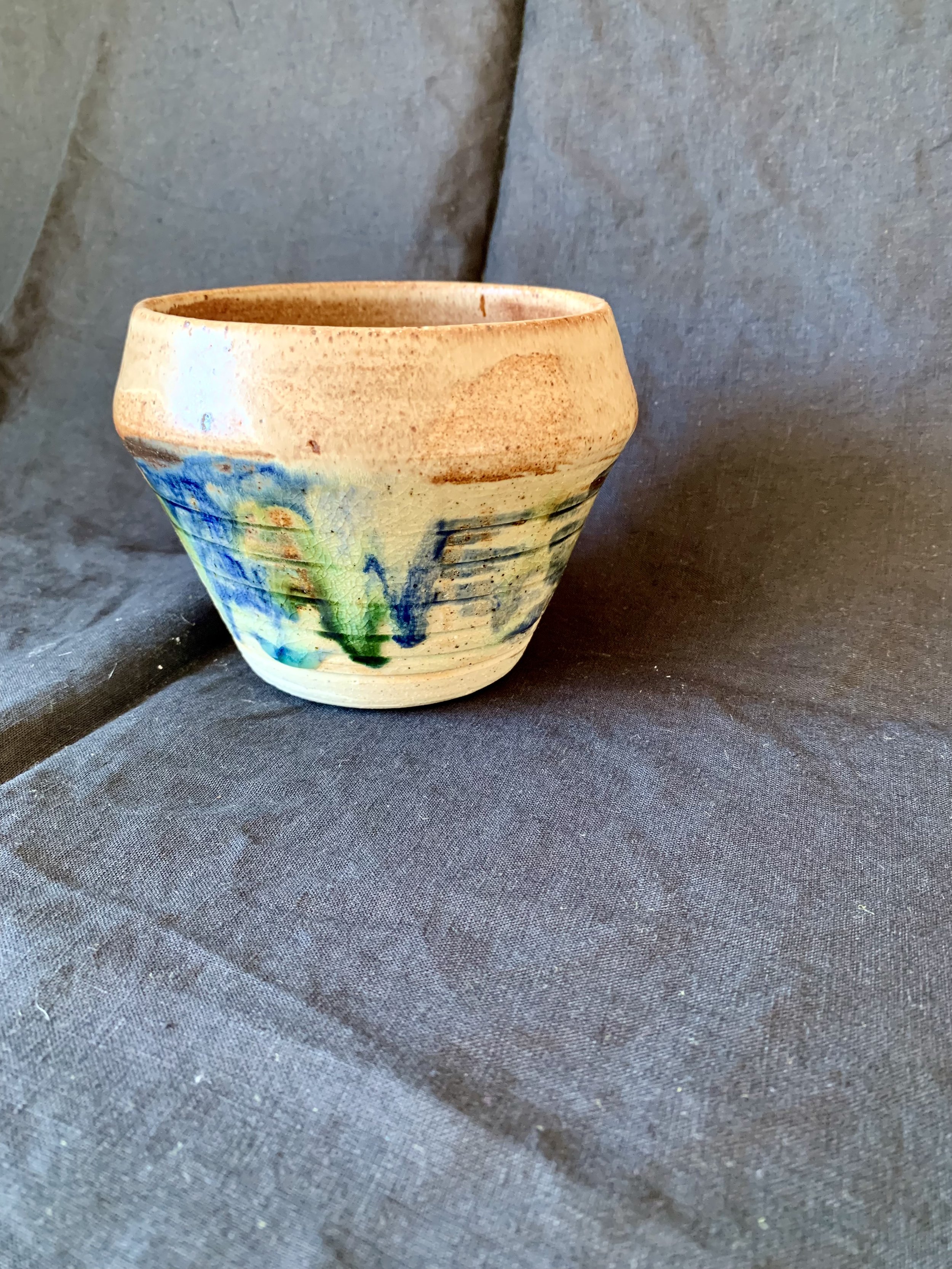 Stoneware vessel decorated with oxides and glazes incorporating reclaimed materials