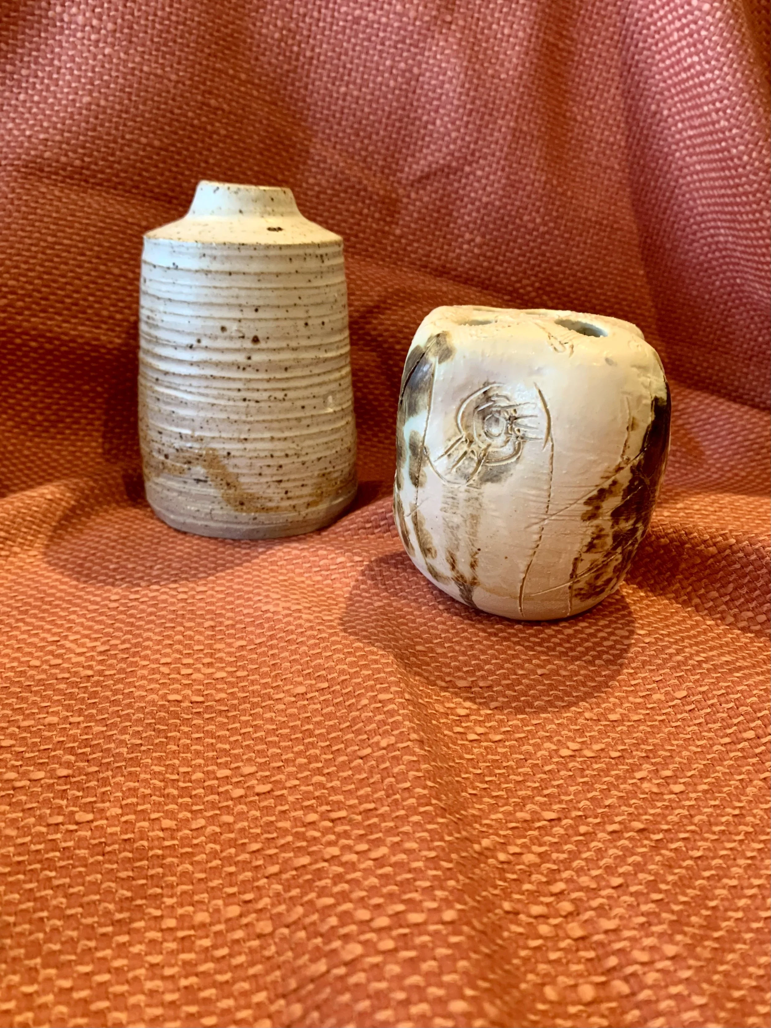 Thrown and altered stoneware vase with texture and oxide colouring and thrown and textured narrow-necked stoneware vase