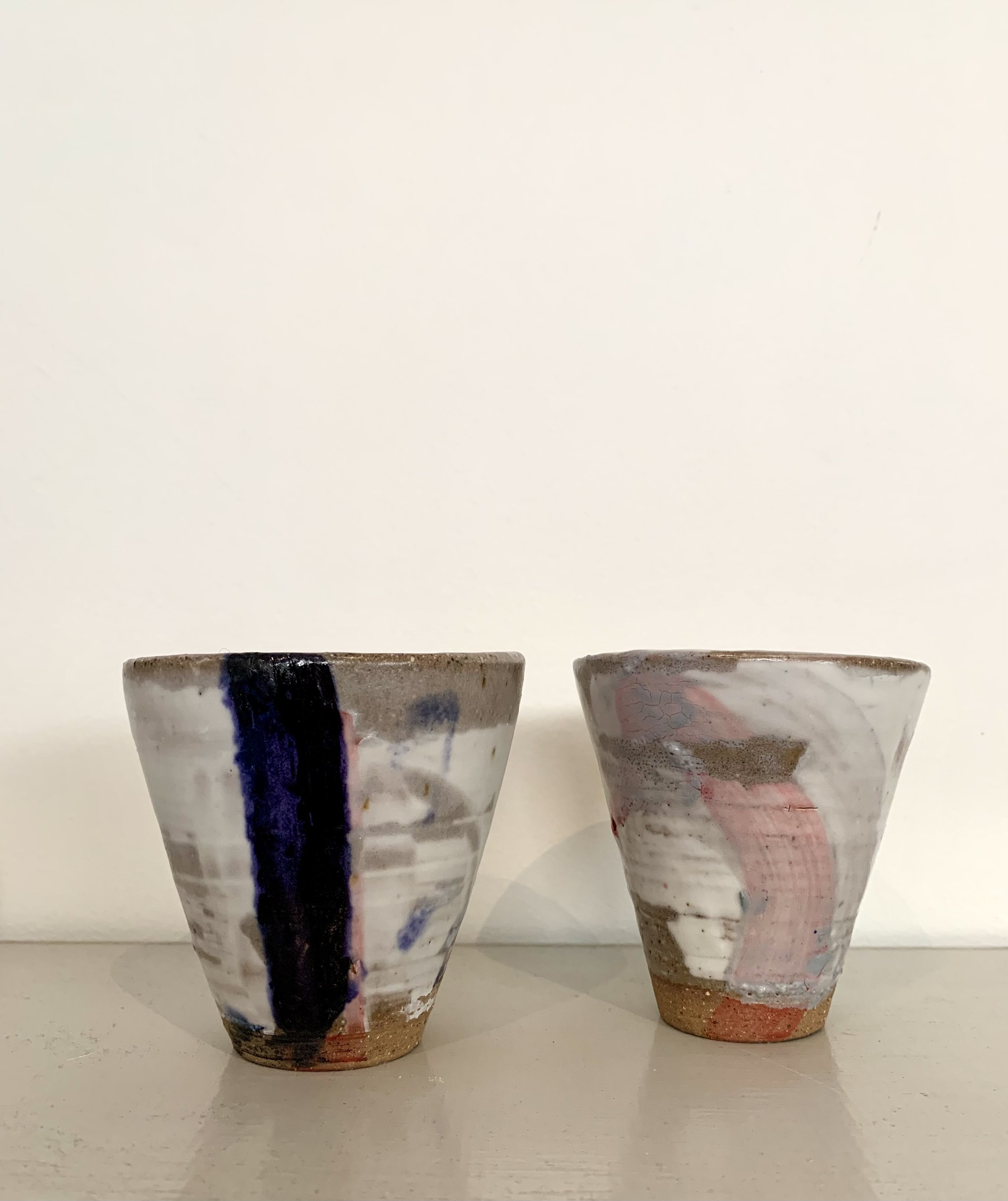 Two slip decorated stoneware tumblers