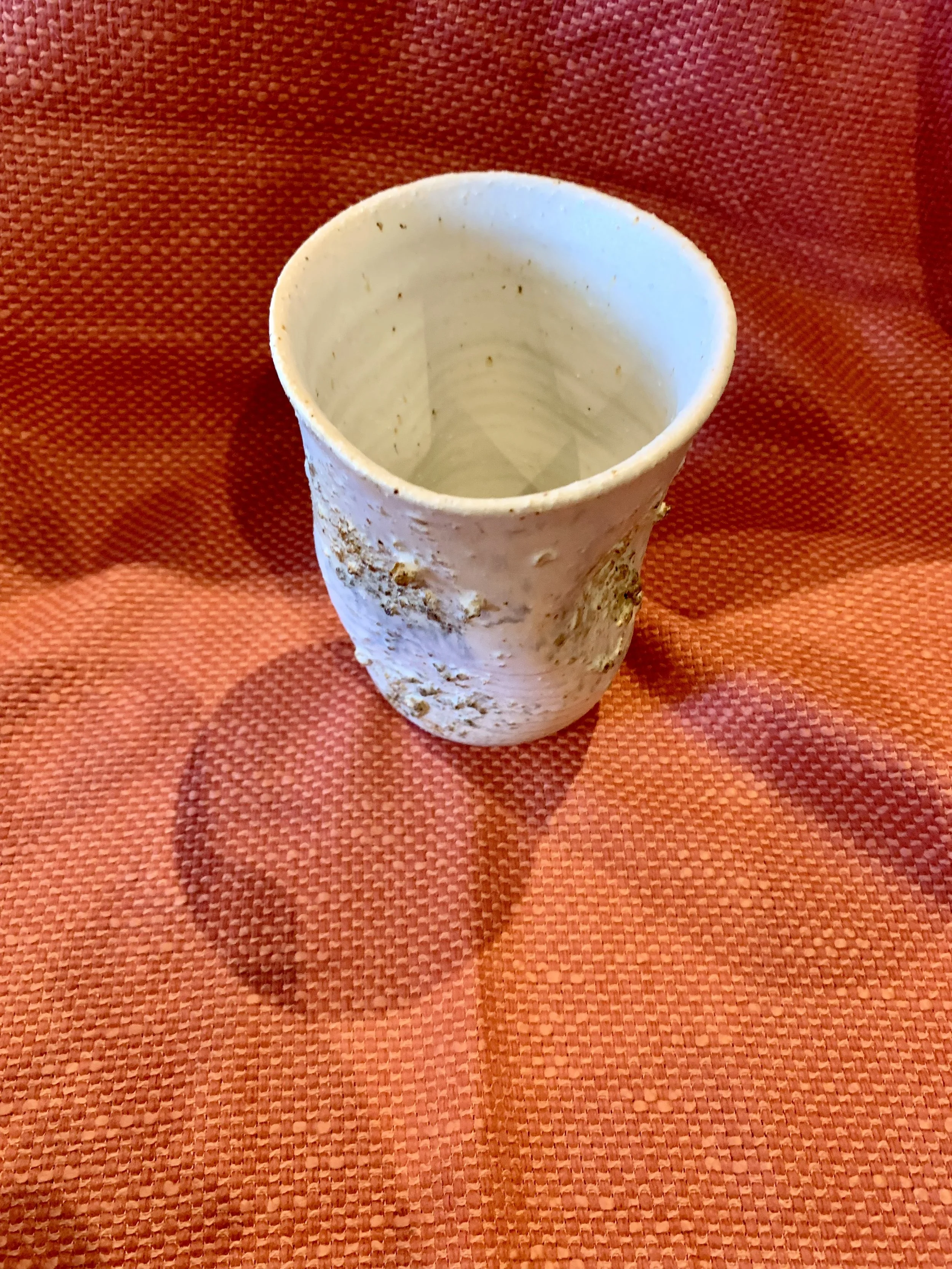 Thrown and altered stoneware vase with texture and oxide colouring