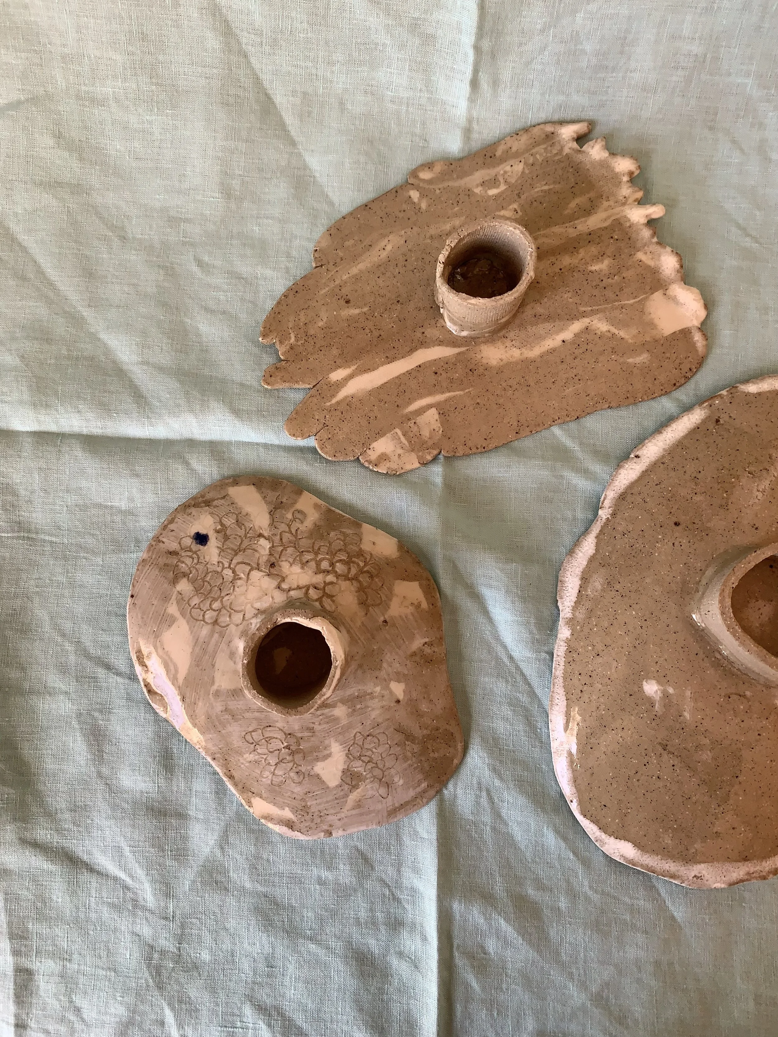 Underside of three medium stilted Nerikomi serving dishes, clear glazed stoneware with slip