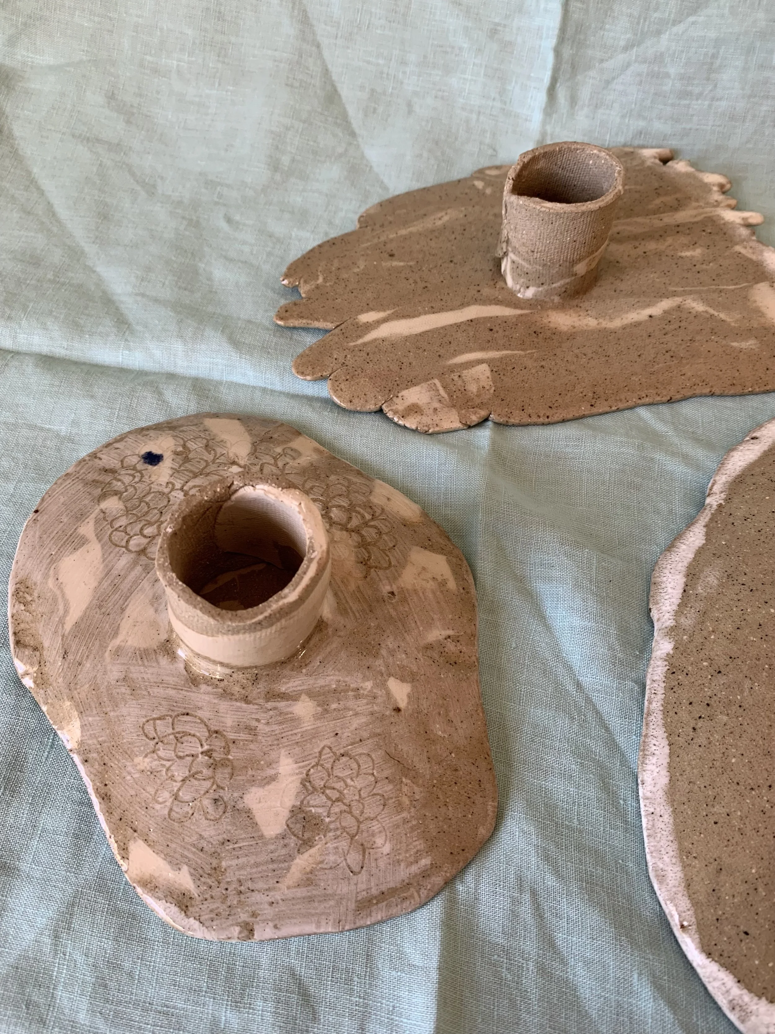 Underside of three medium stilted Nerikomi serving dishes, clear glazed stoneware with slip