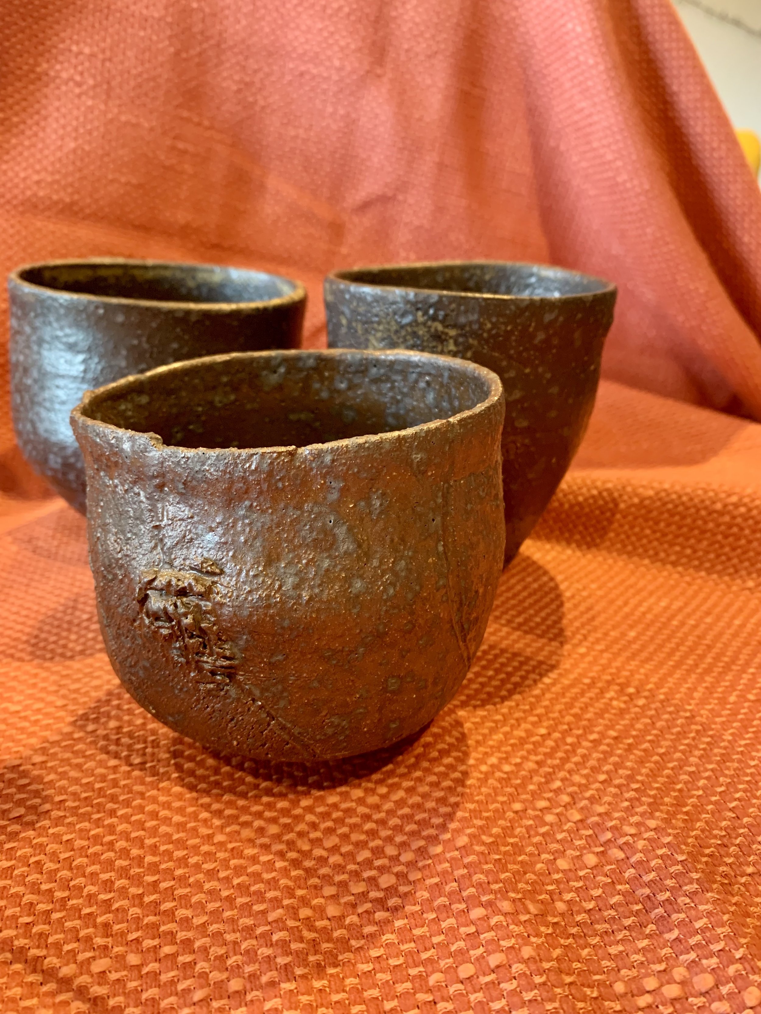 Textured cup, dark reduction fired stoneware