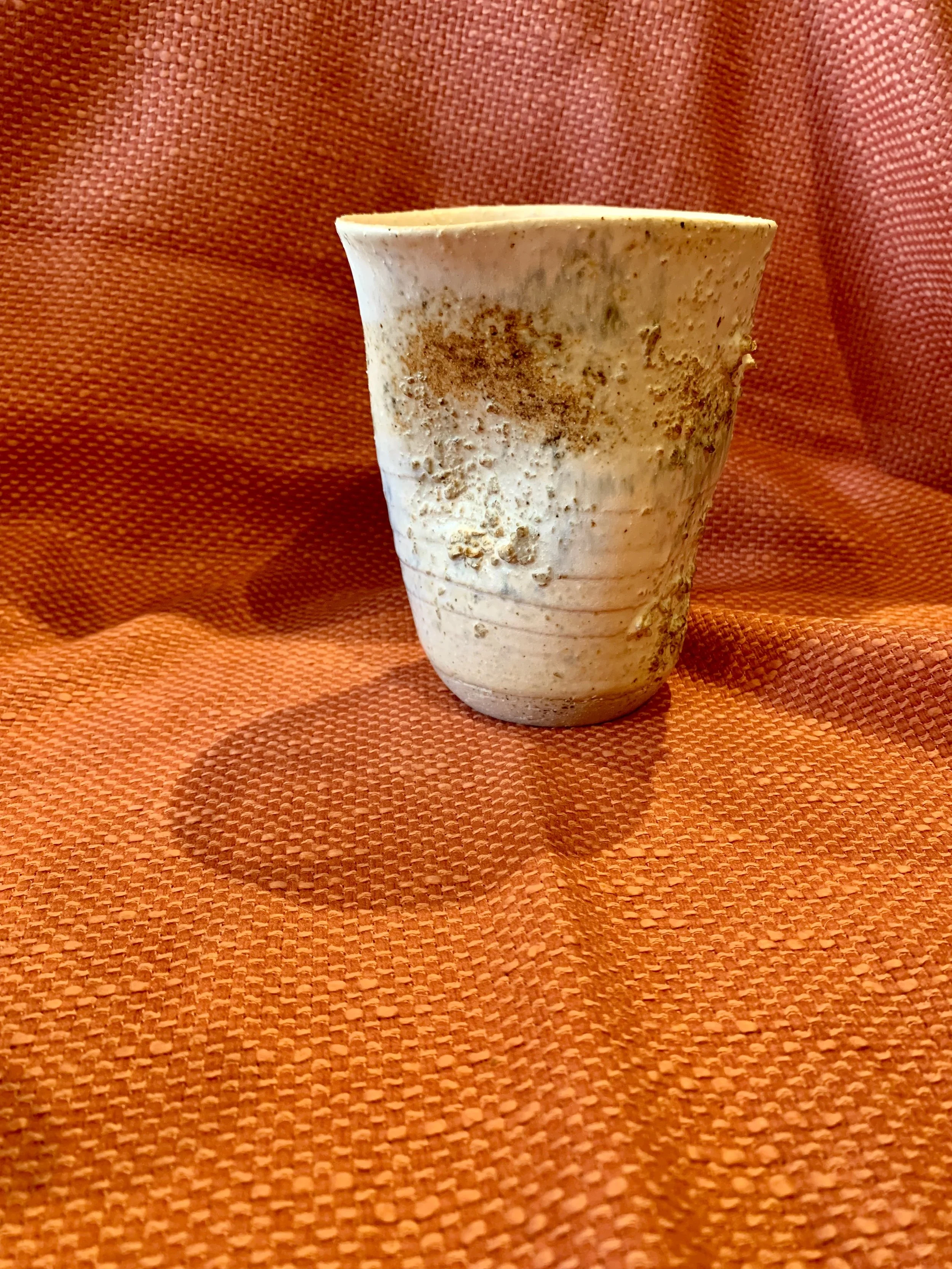 Thrown and altered stoneware vase with texture and oxide colouring
