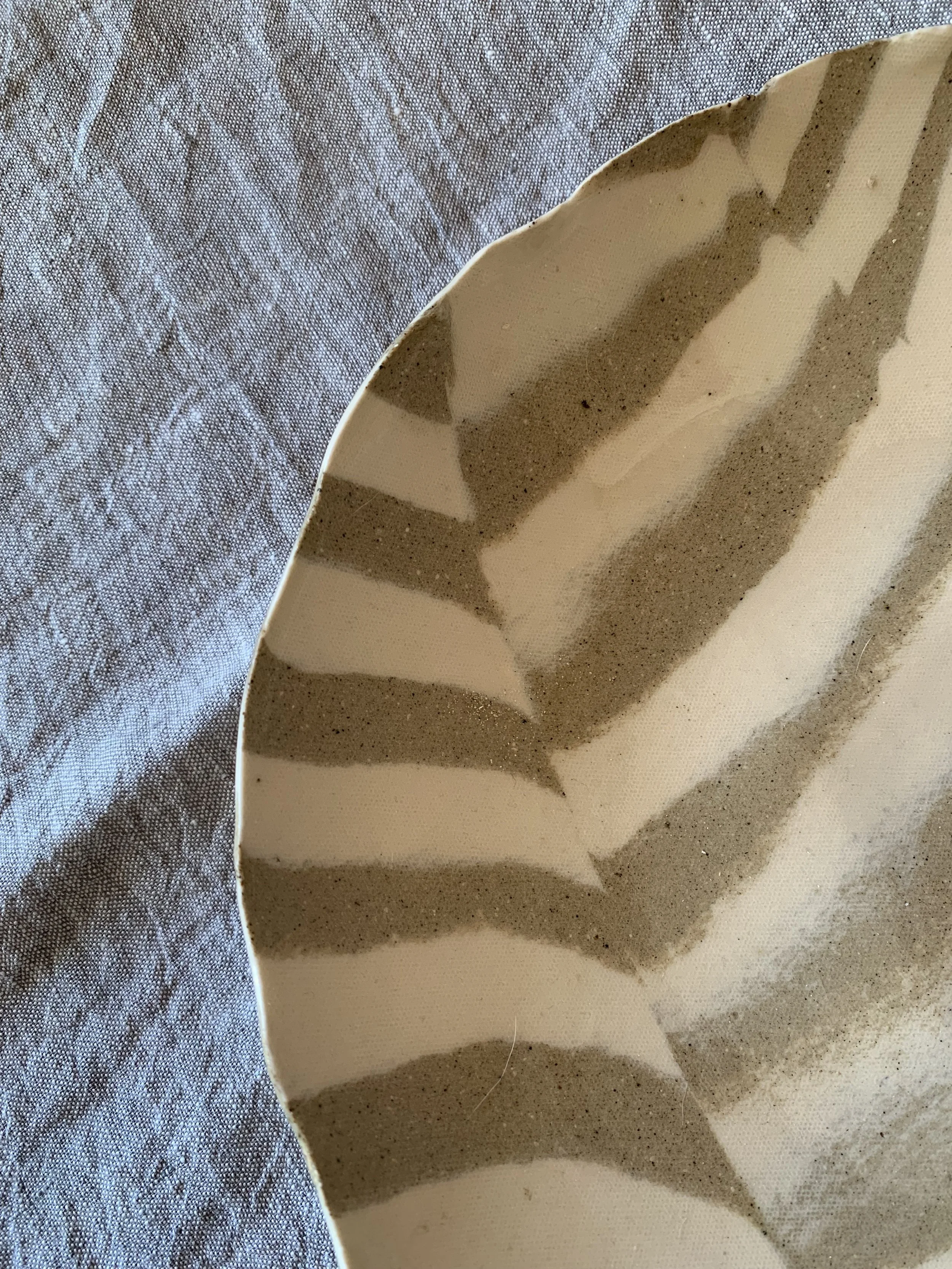 Detail of large striped Nerikomi serving dish, clear glazed stoneware