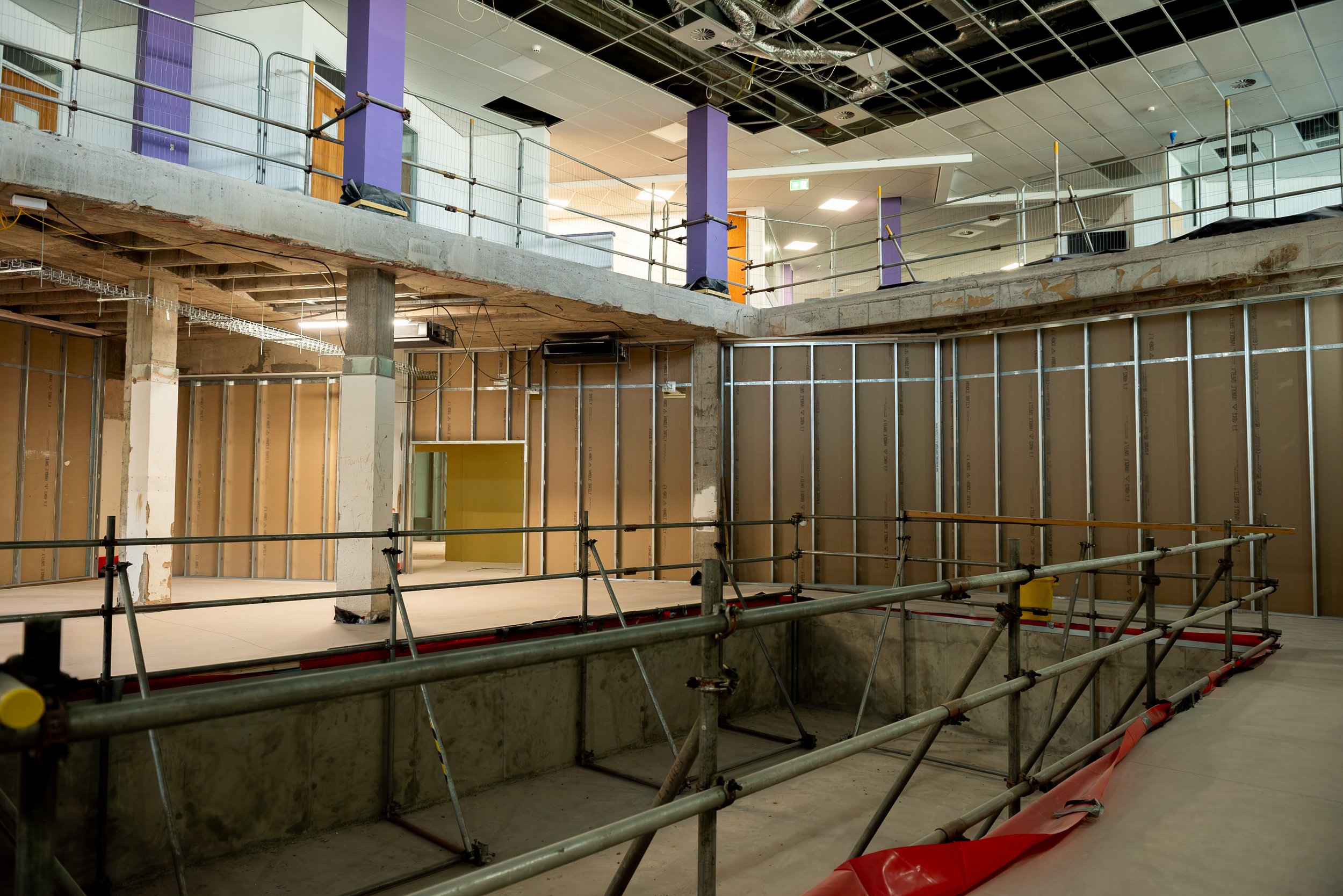 Partitions part-boarded in Siniat board, with a mobile scaffold tower set up for high-level work