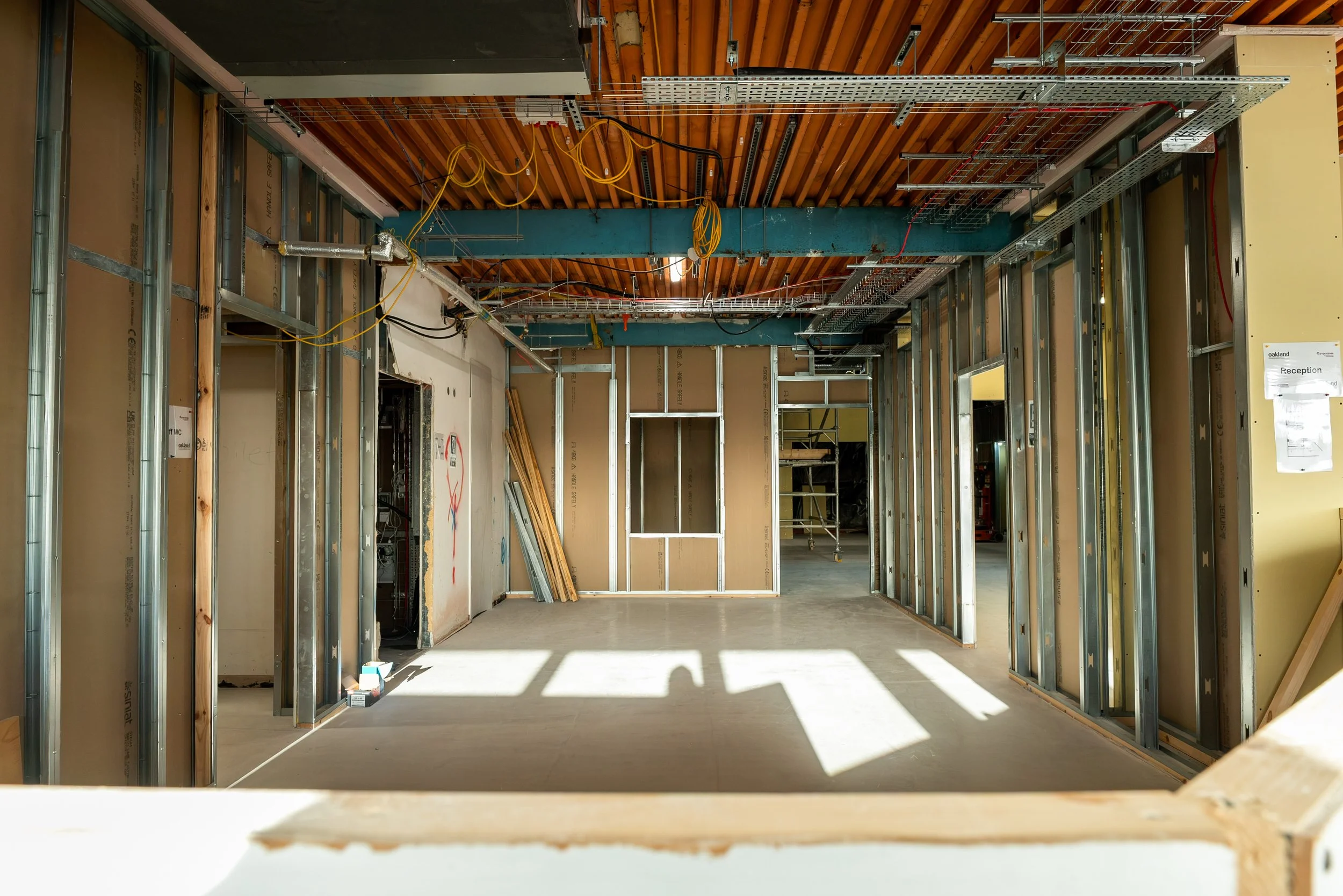 Studwork beside the windows, timber ceiling joists above Metal stud partitions and Siniat board going up beside the original windows at the Gympanzees Centre, Aust