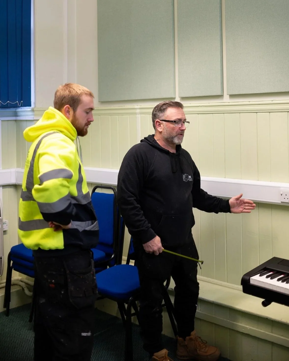 Two Men with Measuring Tape