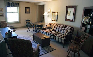 The upstairs sitting parlor features a fireplace and handcrafted paneled cabinets.