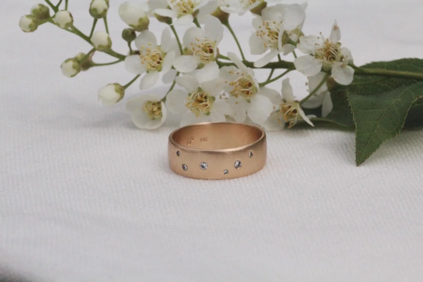 A recent custom wedding band with scattered diamonds for a couple who got married last weekend. Made using the gold from her mother&rsquo;s 18k wedding band for an extra touch of meaning. Congratulations C &amp; S!!