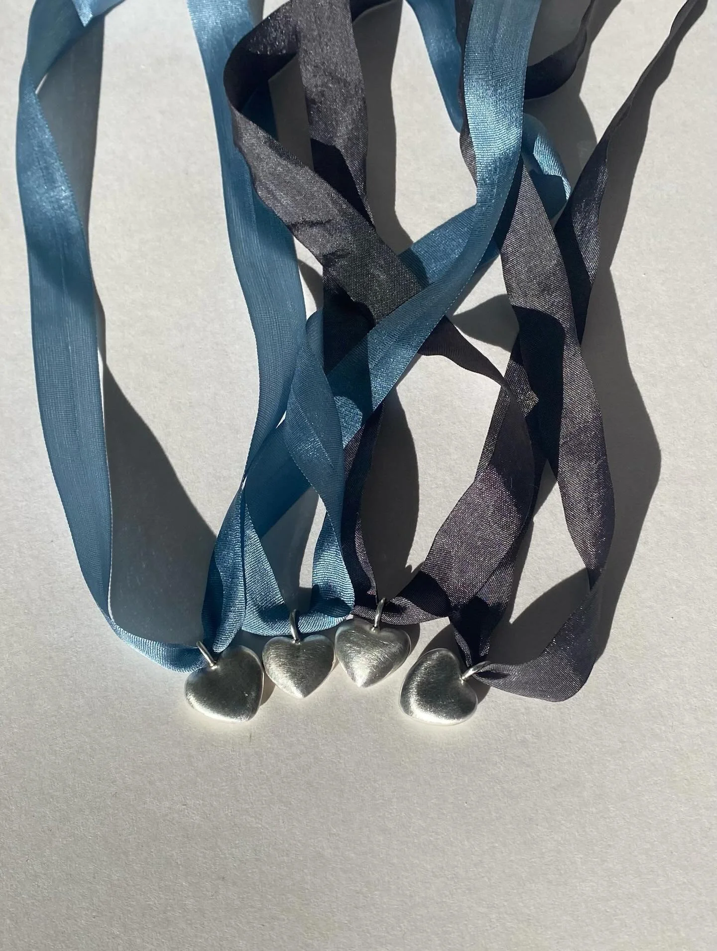 New heart pendants just added to my website! These are sand-cast individually in recycled sterling silver, giving each one a unique texture reminiscent of river rocks. Like little heart rocks to remind you to live a heart-centered life. 

Available o