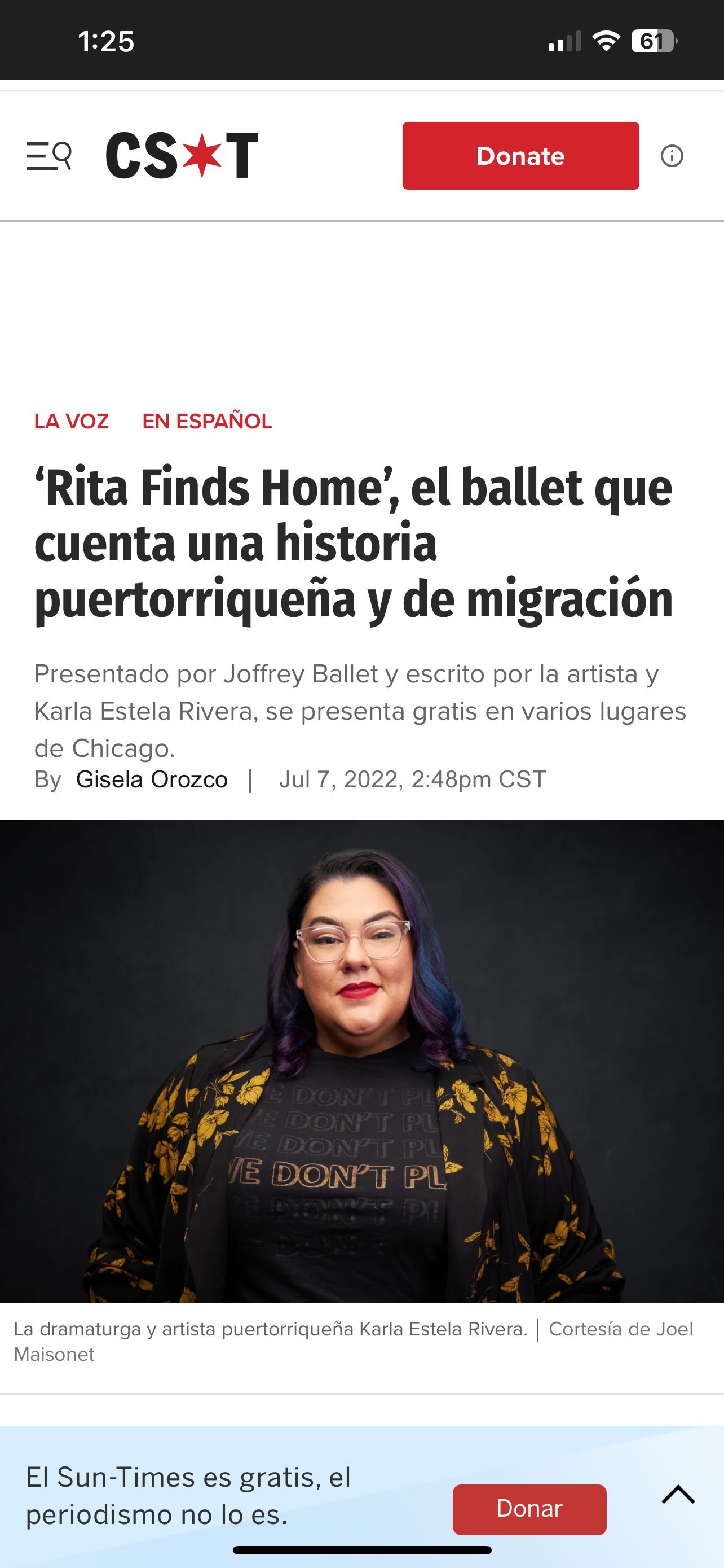 Portrait of Karla Estela Rivera, a Puerto Rican playwright and artist, wearing glasses and a black shirt with a patterned jacket, against a dark background.