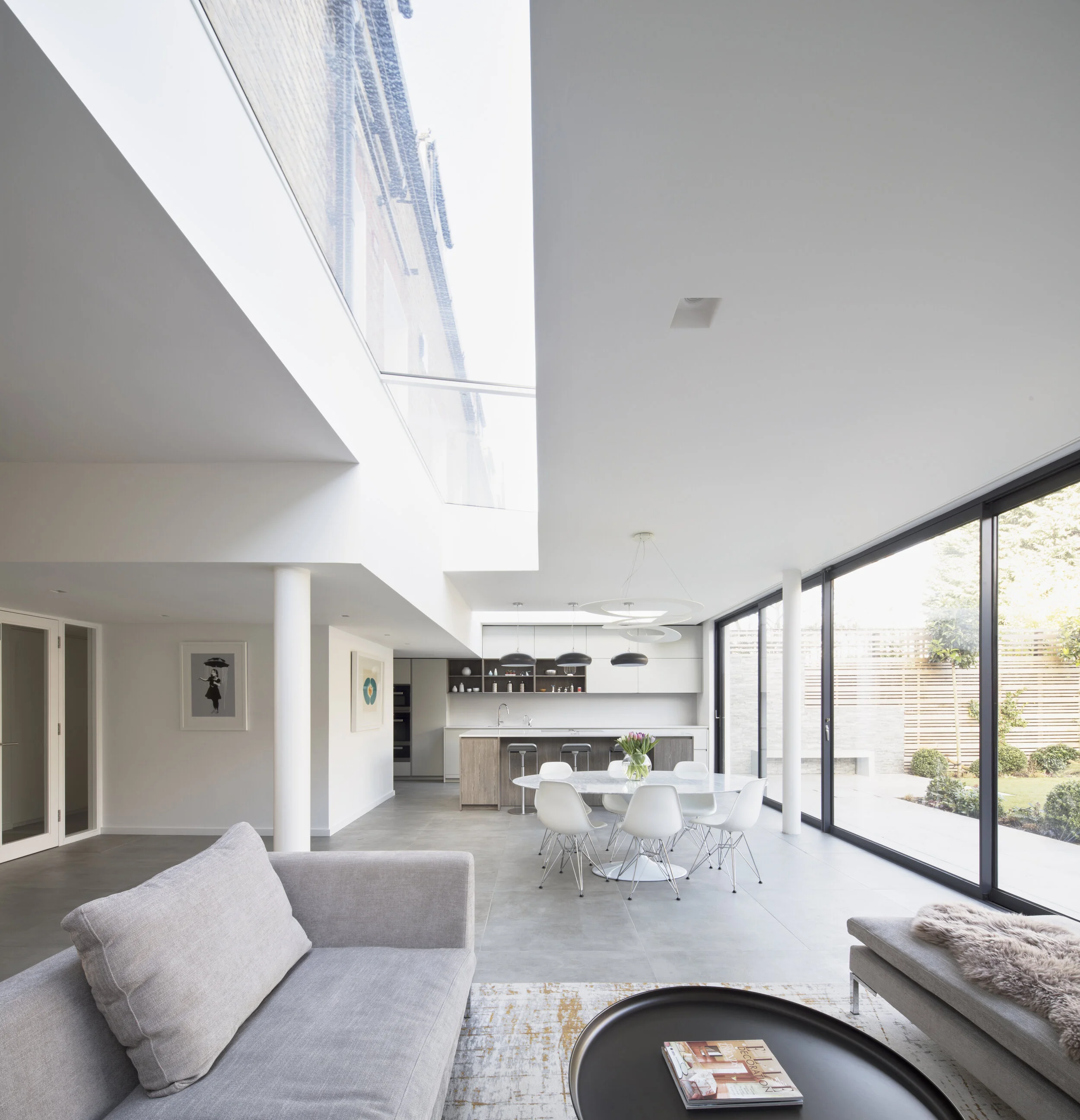 Architects in London. Design ideas for open plan kitchen with sliding glazed doors and kitchen island.