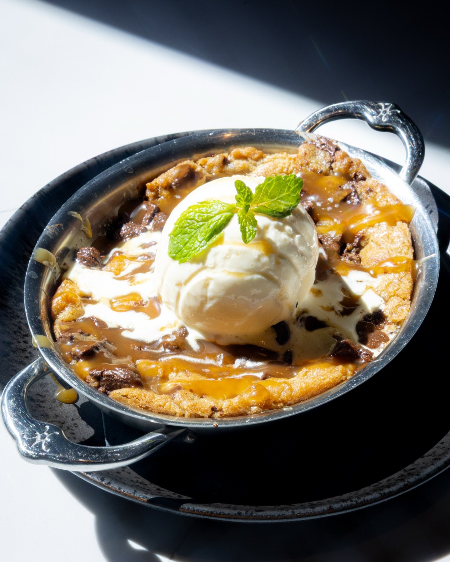 Elevate your spring break with a Barrel &amp; Derrick dessert, such as our Brown Butter Skillet Cookie. Crafted with vanilla ice cream, caramel, and sea salt, this indulgence completes your meal. Order yours today and treat yourself!