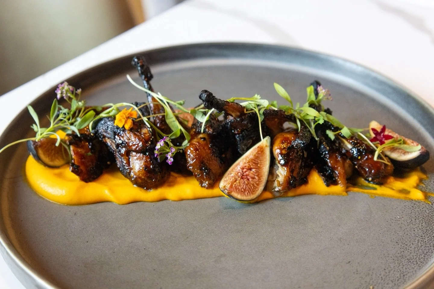 Bring your appetite to Barrel &amp; Derrick and indulge in the Lockhart Bandera Quail, featuring a flavorful carrot puree, black mission figs, and fresh dressed greens. It&rsquo;s the ideal appetizer to kick off your evening of delightful bites.