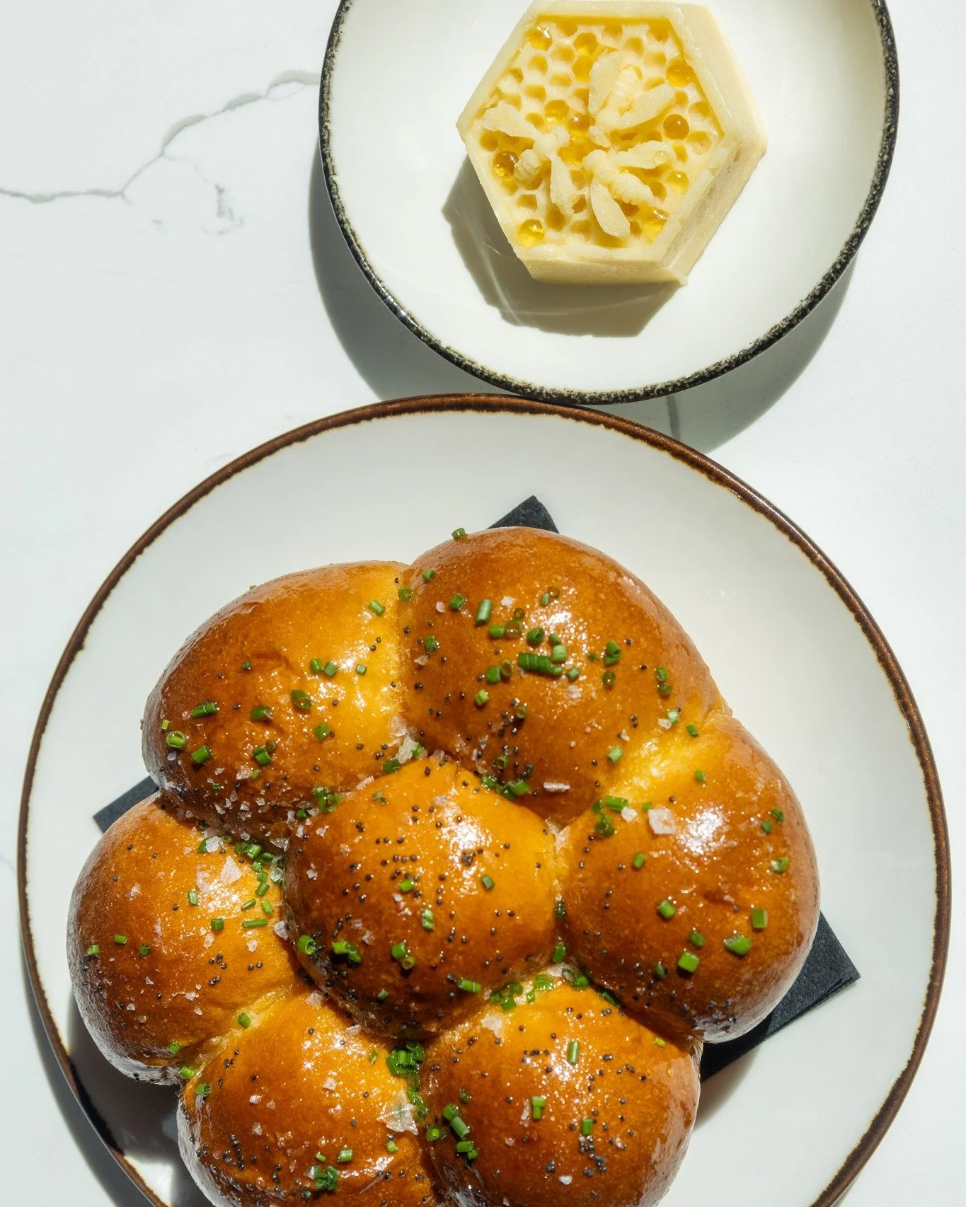 Try our fresh Brioche Pull Aparts served with mouthwatering browned honey butter when you dine at Barrel &amp; Derrick.