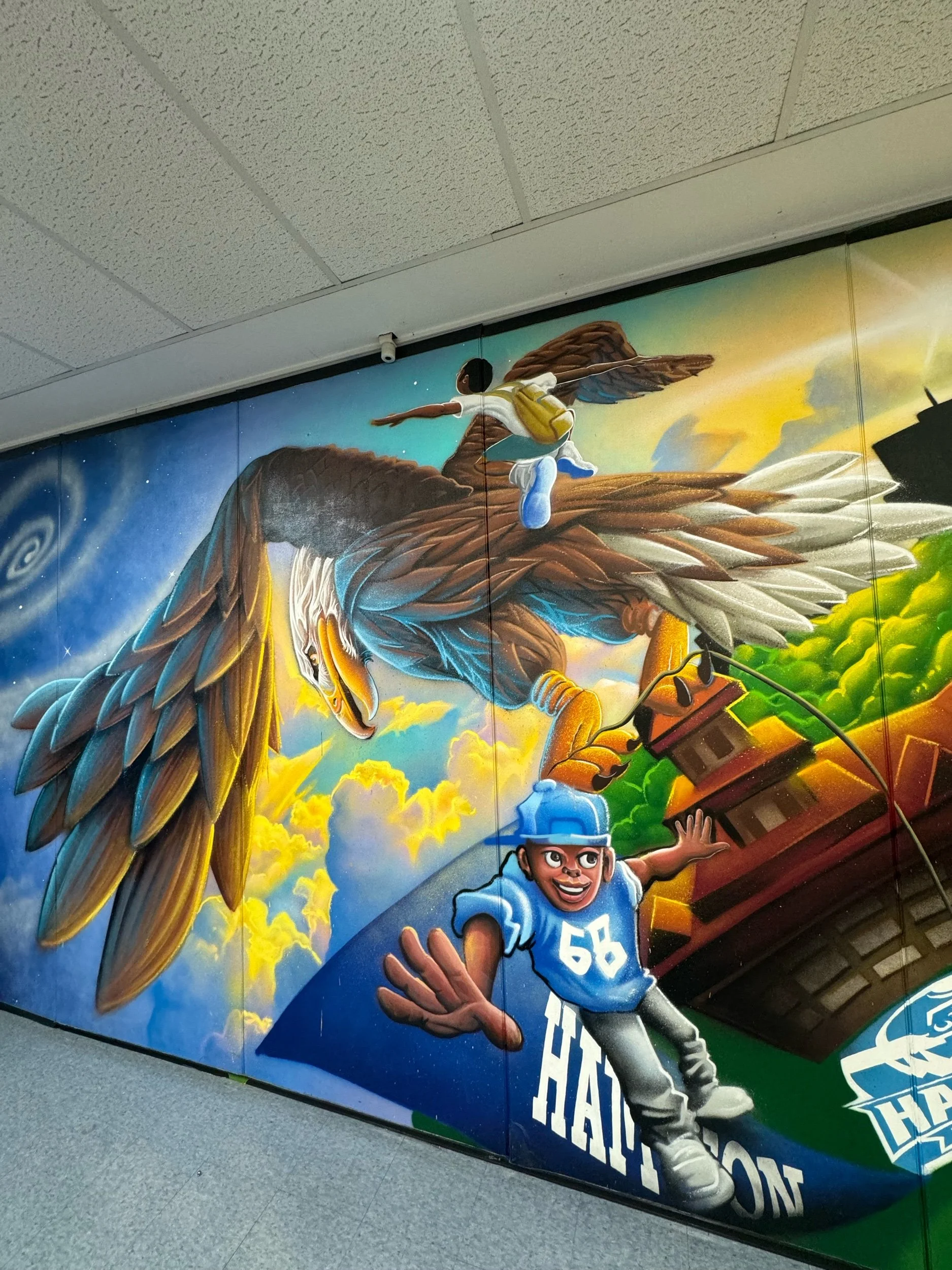 This mural designed in a collaboration between Lamont Draper Jr aka “Half Past Full” and Elijah Minton “The Art Alchemist.