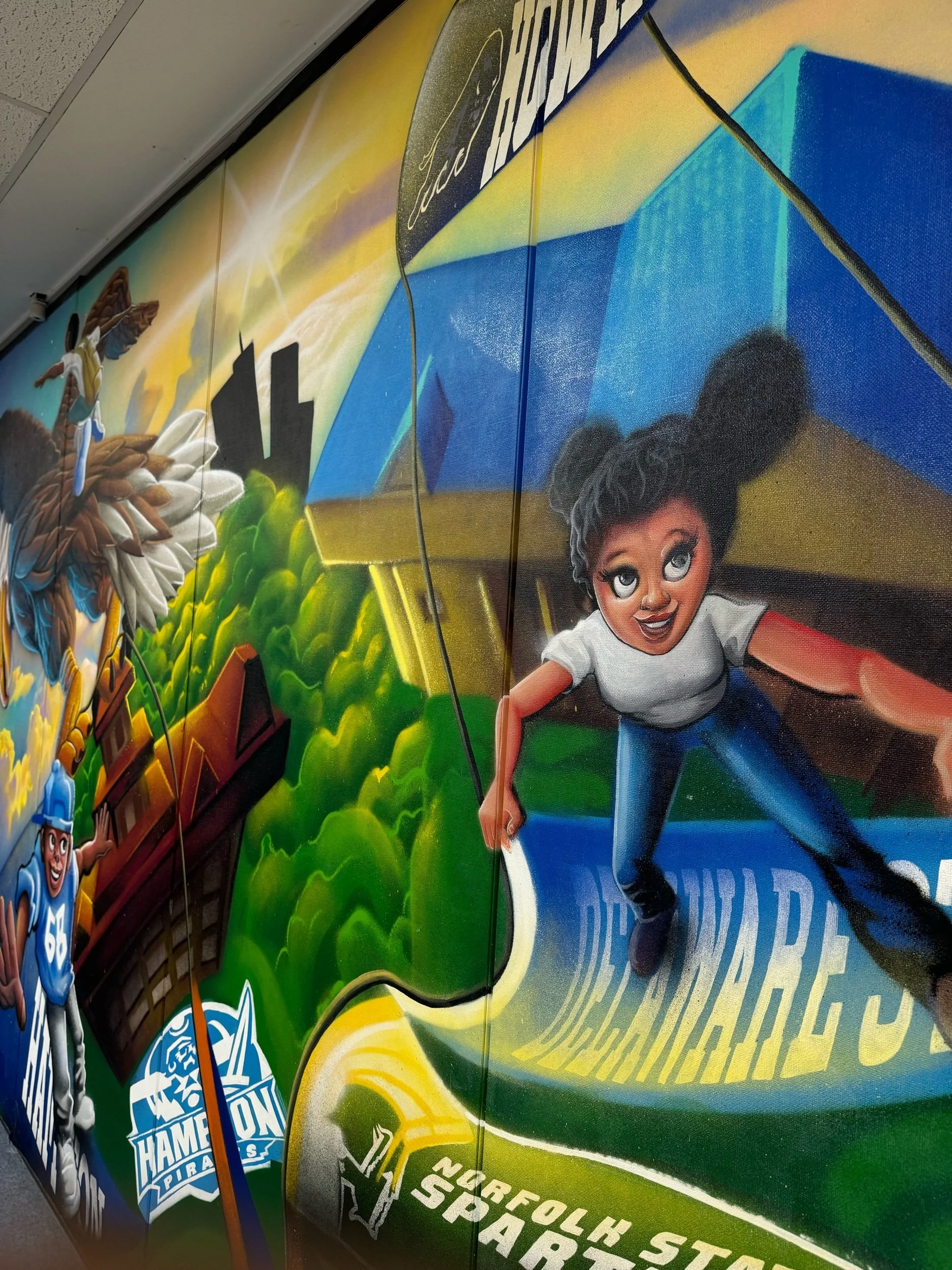 This mural designed in a collaboration between Lamont Draper Jr aka “Half Past Full” and Elijah Minton “The Art Alchemist.