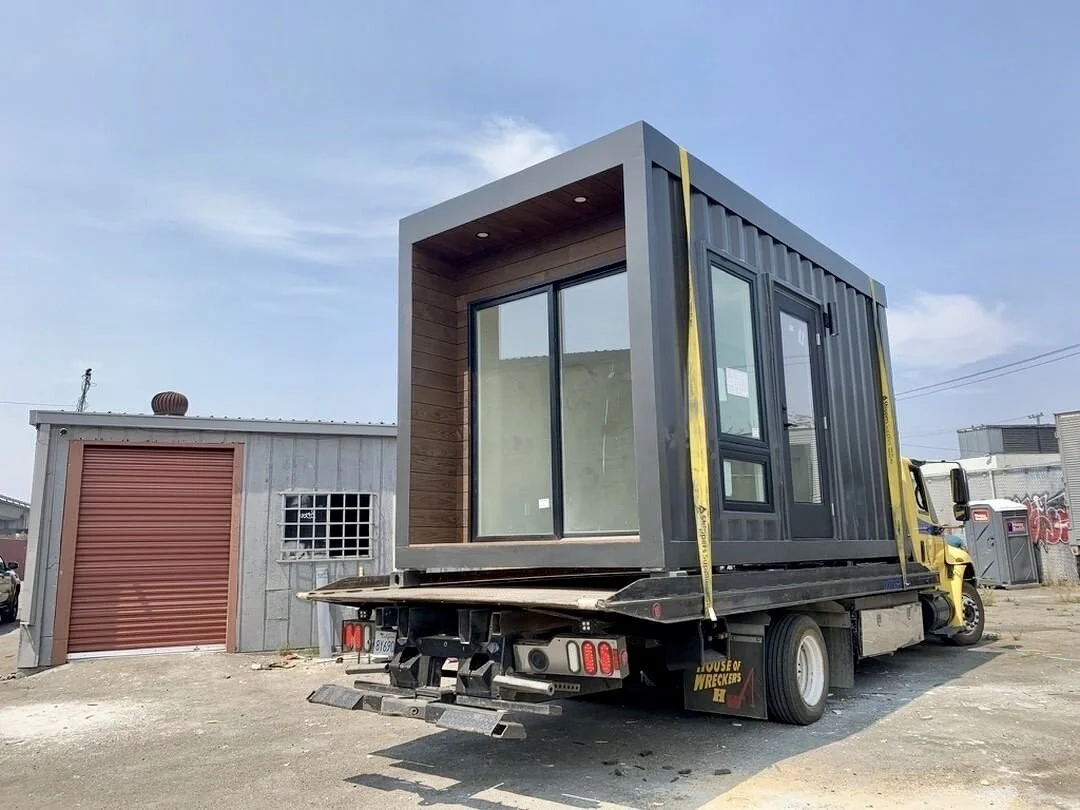 A finished Bay Modular ADU module strapped to a flatbed truck for delivery