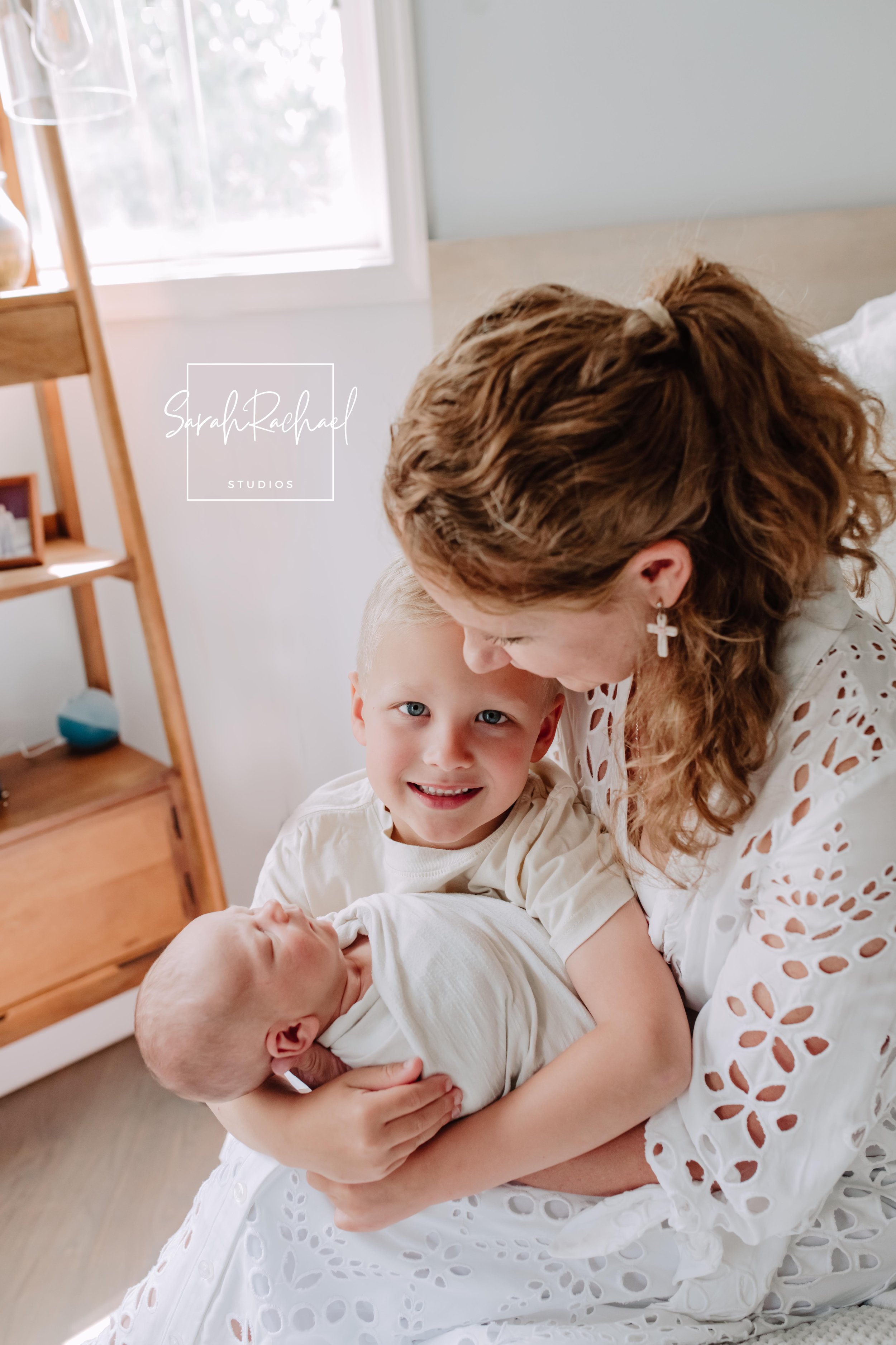 Family holding newborn baby during relaxed in-home photography session in Frederick MD.