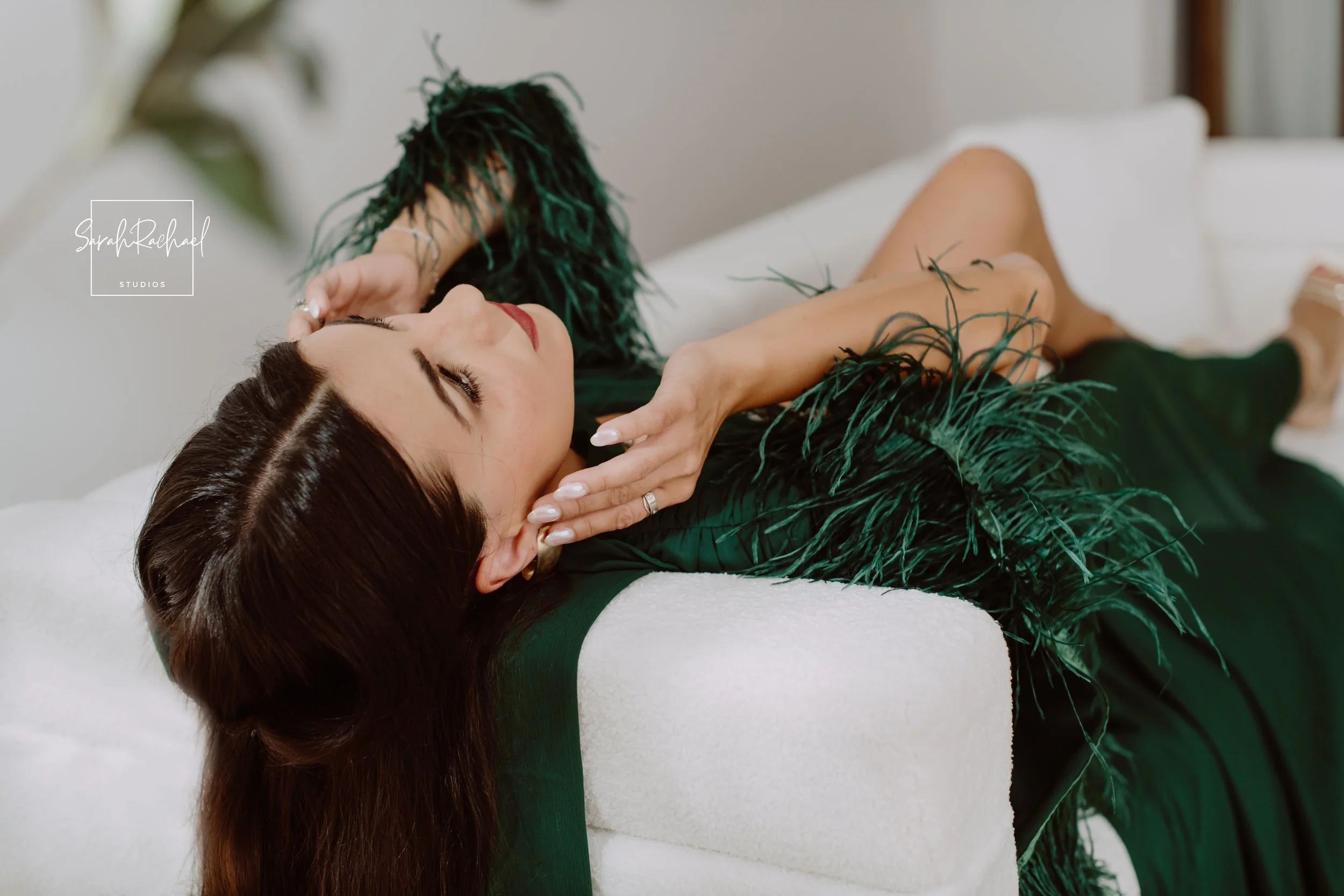 influencer/model fashion photoshoot, model posing on a sofa.