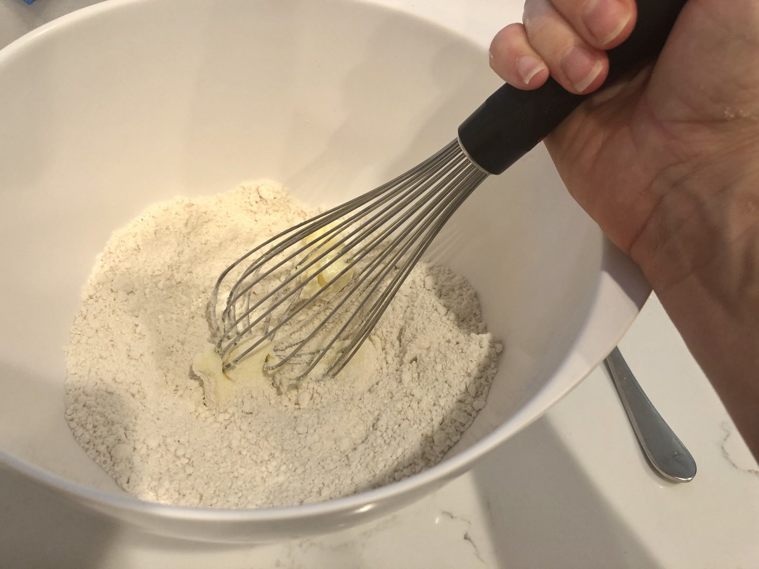  Mix vigorously until the butter is completely mixed with the Bisquick and sugar. 