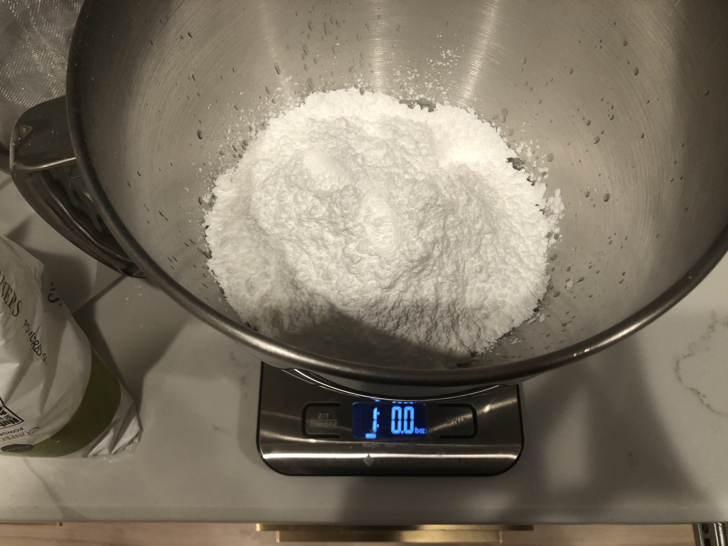  Then add the pound of confectioners sugar to the egg whites.  It’s best to sift the confectioners sugar so that there are no lumps but I am too lazy for that. 