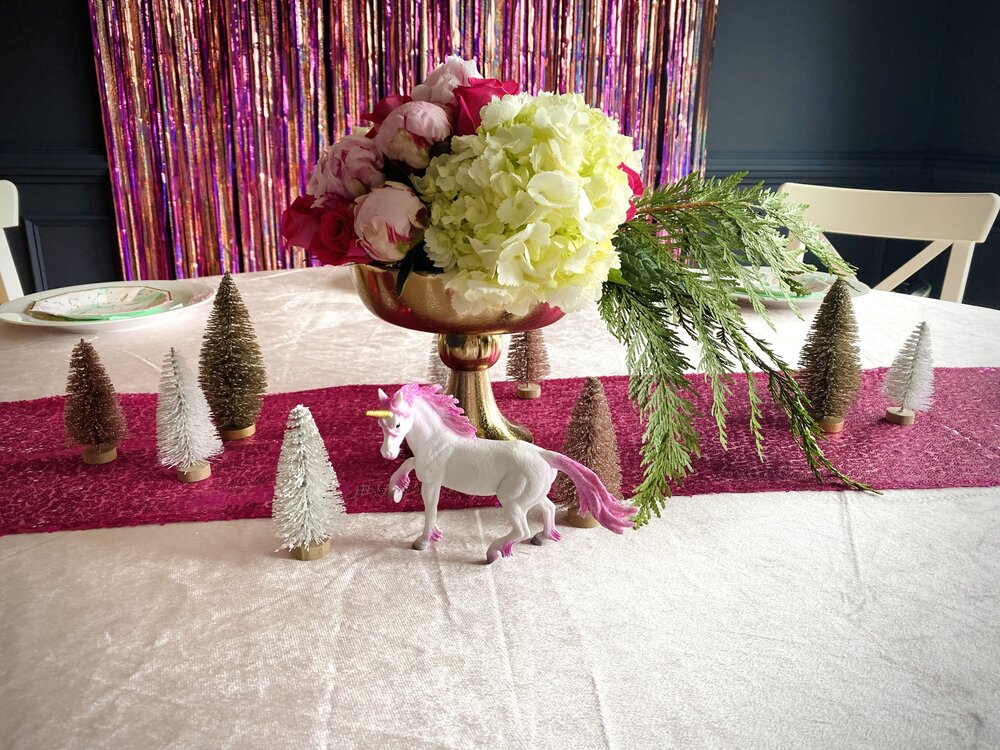  Shimmery bottle brush trees and unicorns were a fun addition to the floral centerpiece. 