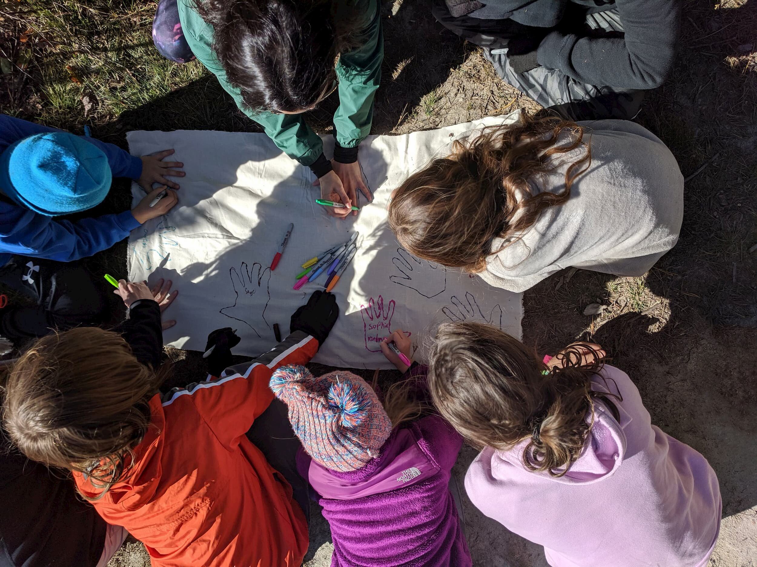 kids-outside-with-hand-poster.jpg