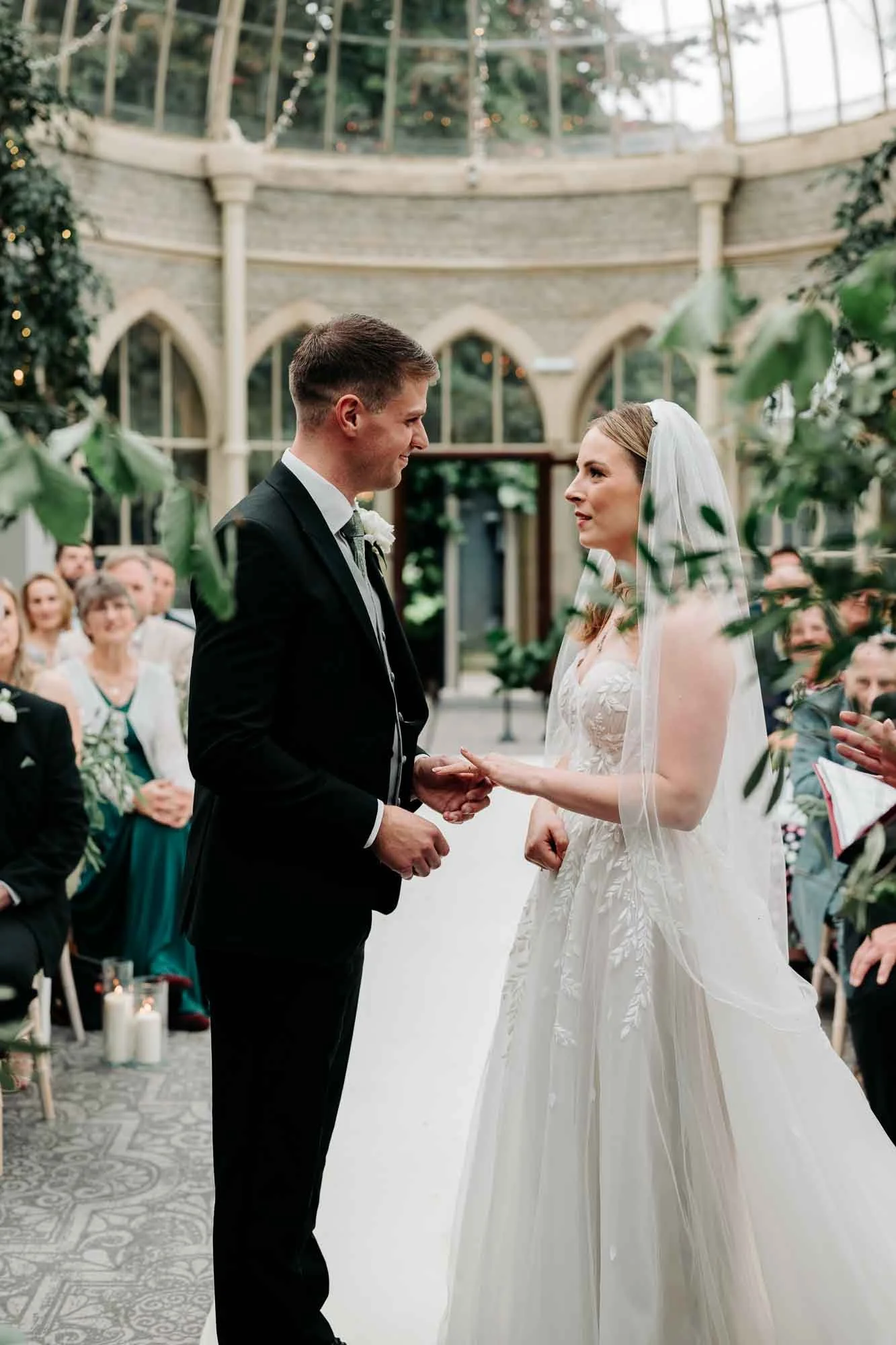  couple exchange rings at tourtworth court wedding ceremony in the orangery  