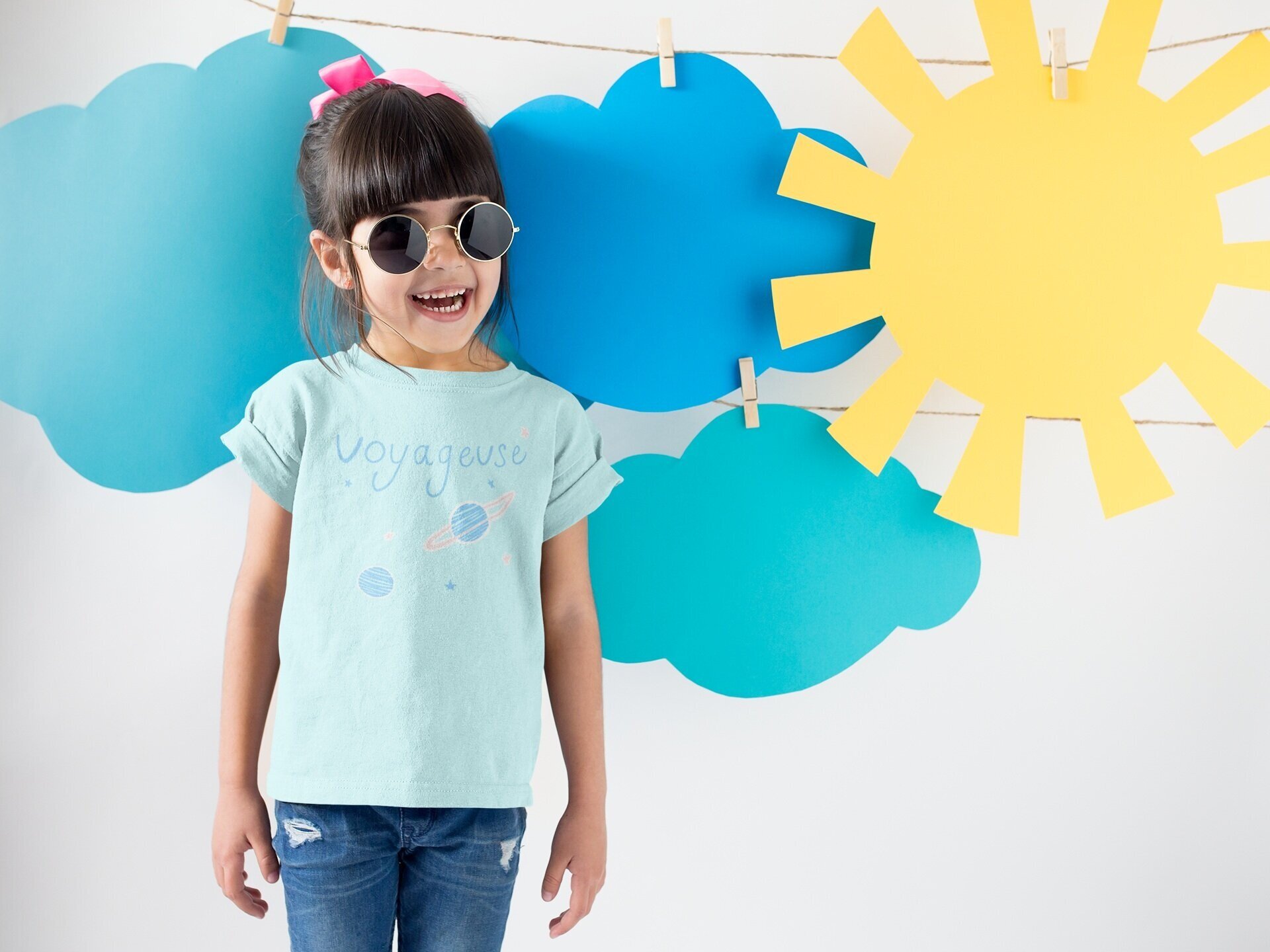 smiling-girl-wearing-a-round-neck-tshirt-template-near-cardboard-sun-and-clouds-a19480.jpg