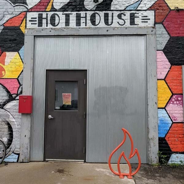  Photo of building entrance. Above the door says “hothouse” 