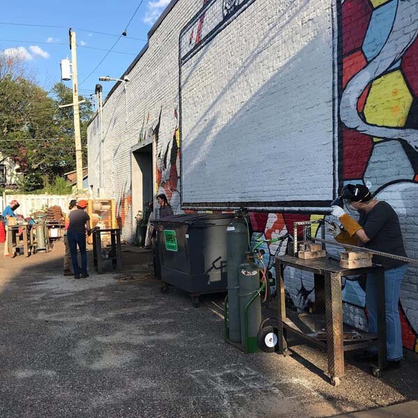  Photo of Oxy-Acetylene welding students working outdoors. 