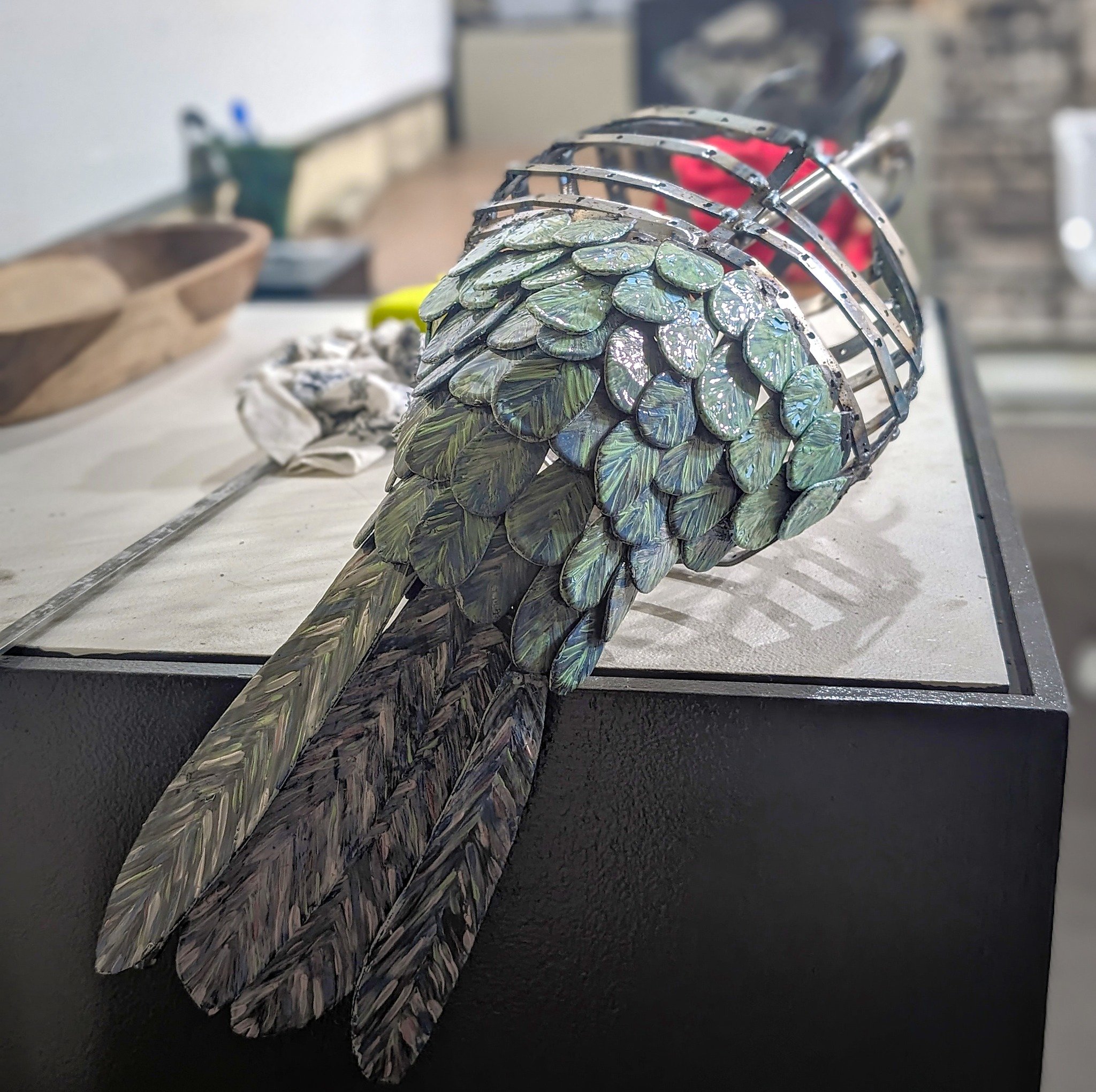 @dani_db_mosaicsarg is hard at work in the CAFAC shop on her next sculpture, an intricate hummingbird made of enameled feathers on a steel frame. Follow her for updates!

[Image descriptions: 1. A view of the hummingbird sculpture as assembled. The t