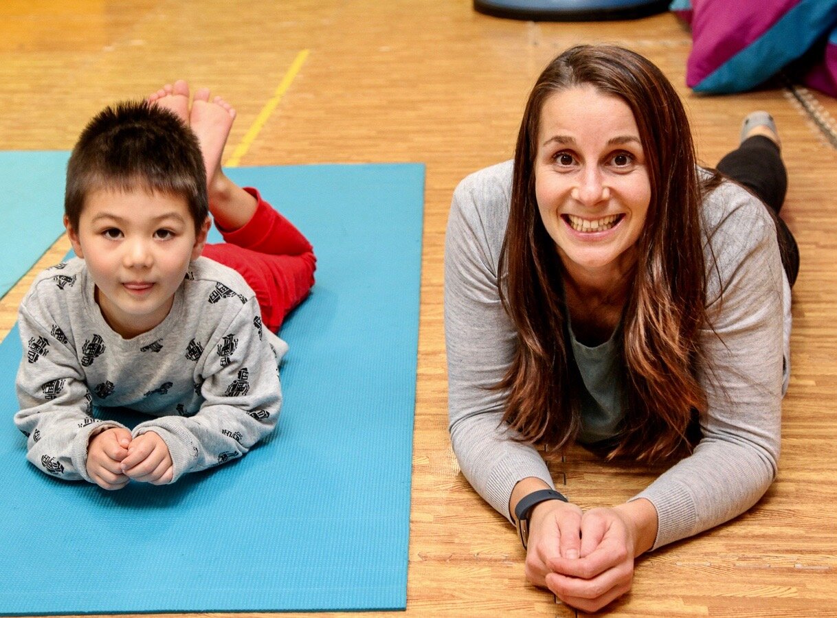Kids First OT Deb doing yoga with young child