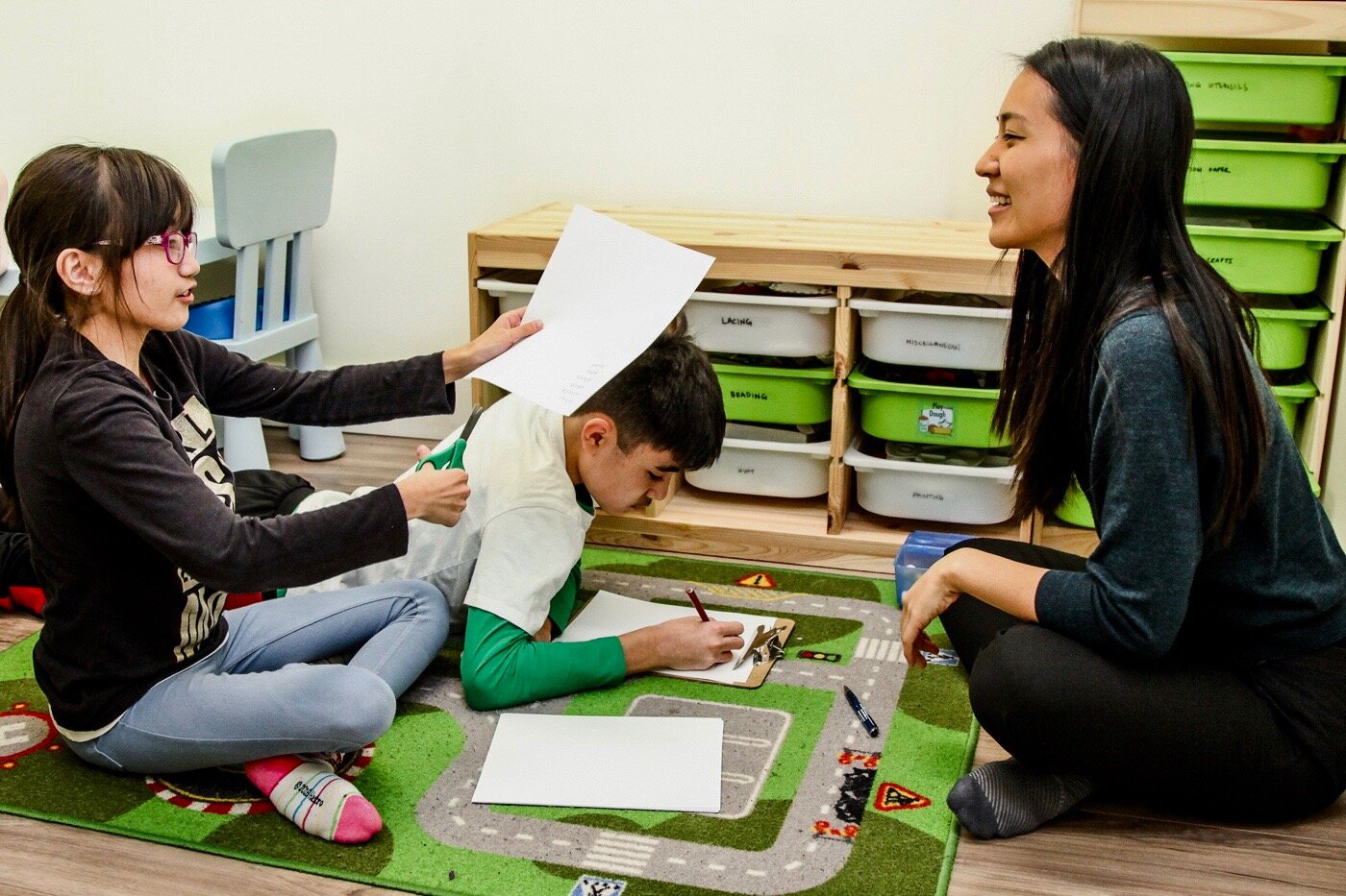 Kids First OT working on printing and social skills with siblings