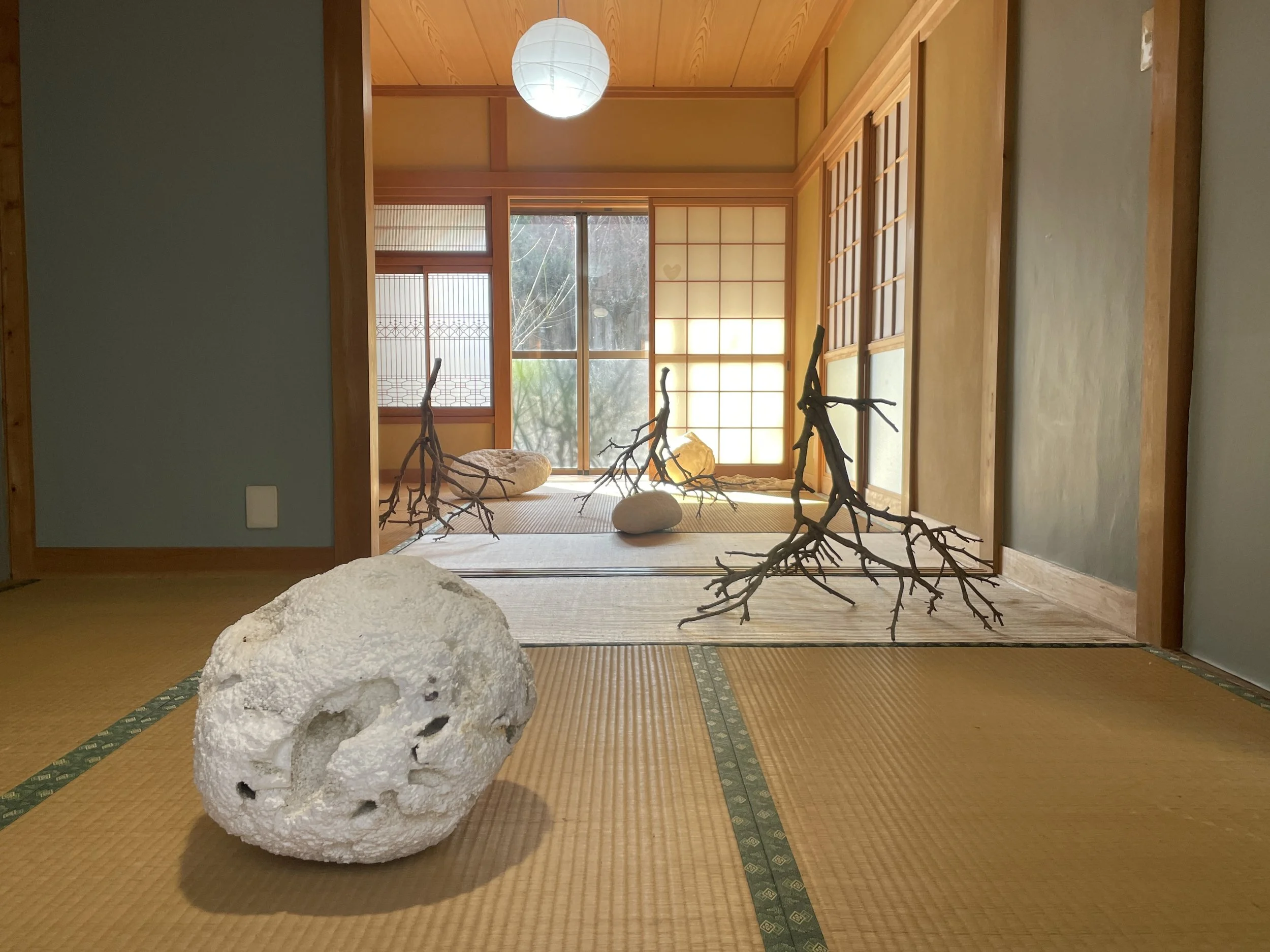Bottom floor installation from A Moment of Time exhibition in Japan. Elements include stick sculptures, pearl bouy cast made of Kozo paper, rope, and naturally tumbled Styrofoam by ocean waves.