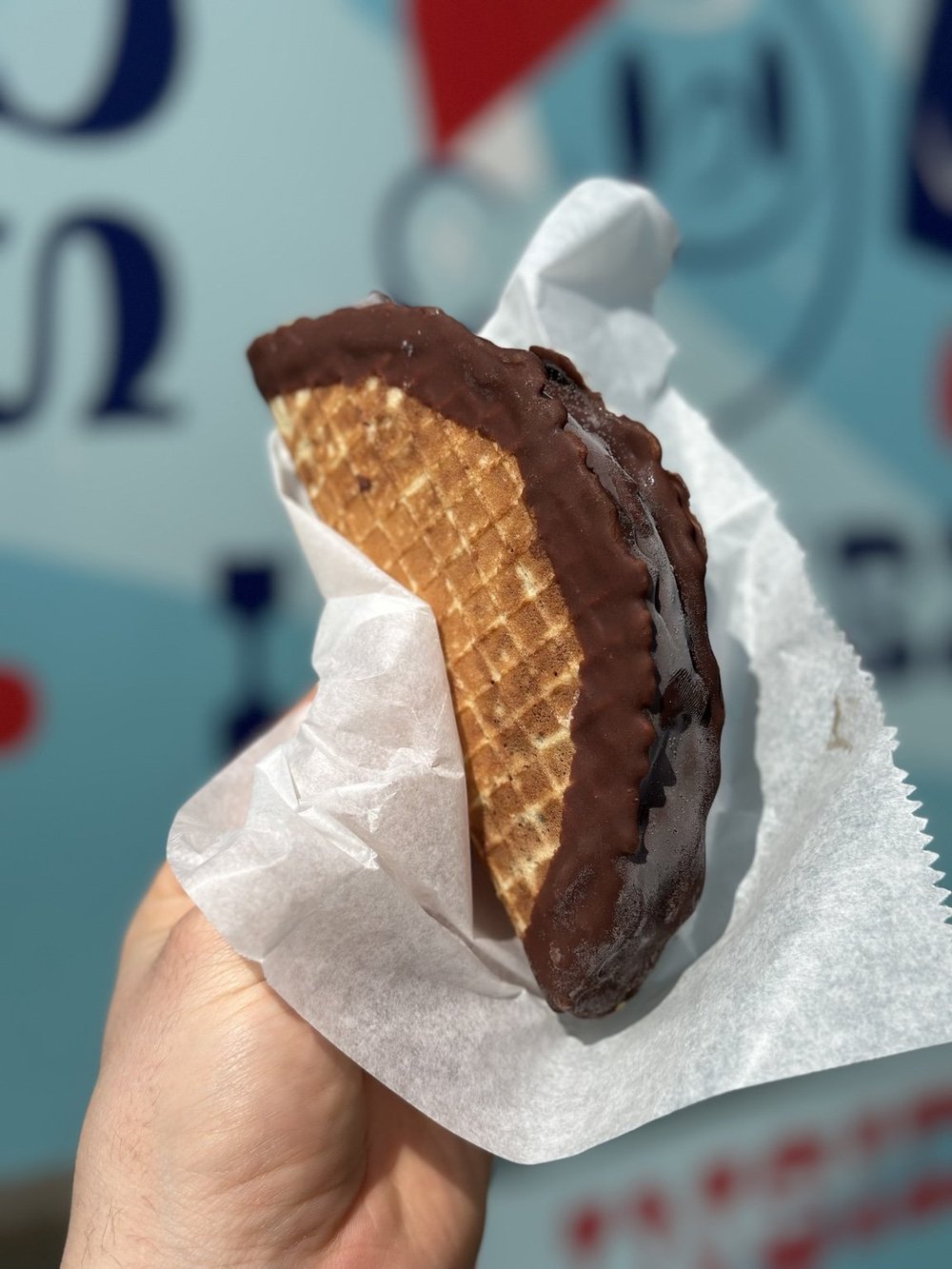 Ice cream taco dessert with chocolate dipped waffle shell