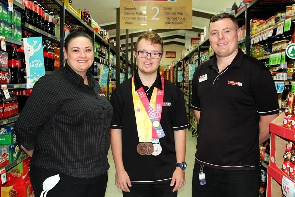 SPAR Woombye manager Kerrie Brakels, staff member Jordan Overs, who recently returned from the Special Olympics World Games in Abu Dhabi with four medals, and Jordan’s immediate supervisor, SPAR Woombye grocery, dairy and freezer operations manager …