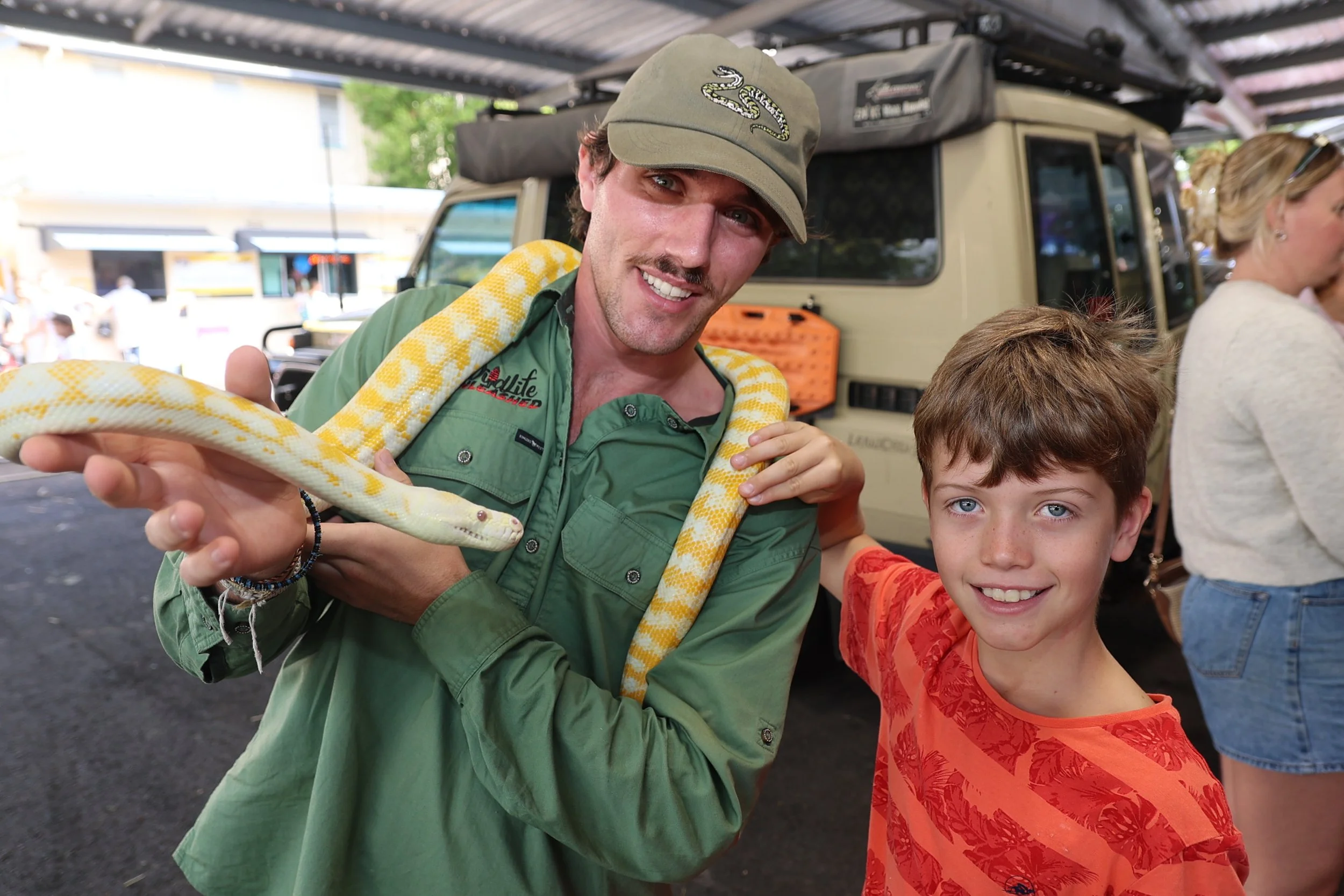show Riegardt from Wildlife Unleashed introduces Sunny the albino Darwin carpet python to a new friend.JPG
