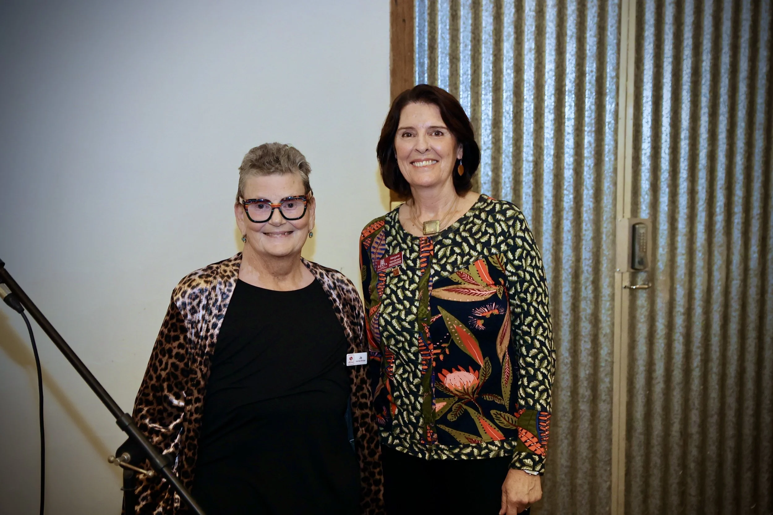 Jo Higgins, from Lily House  accepts a donation from president Margy Henderson.